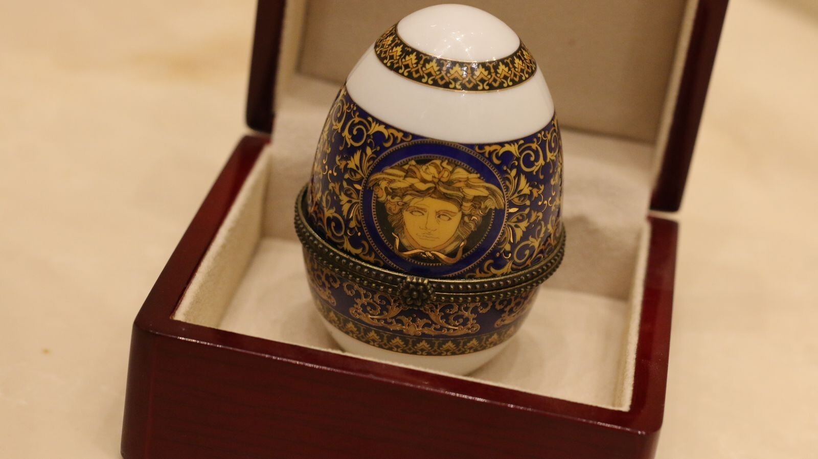Versace Designs egg in white bohemian porcelain with blue and gold Medusa