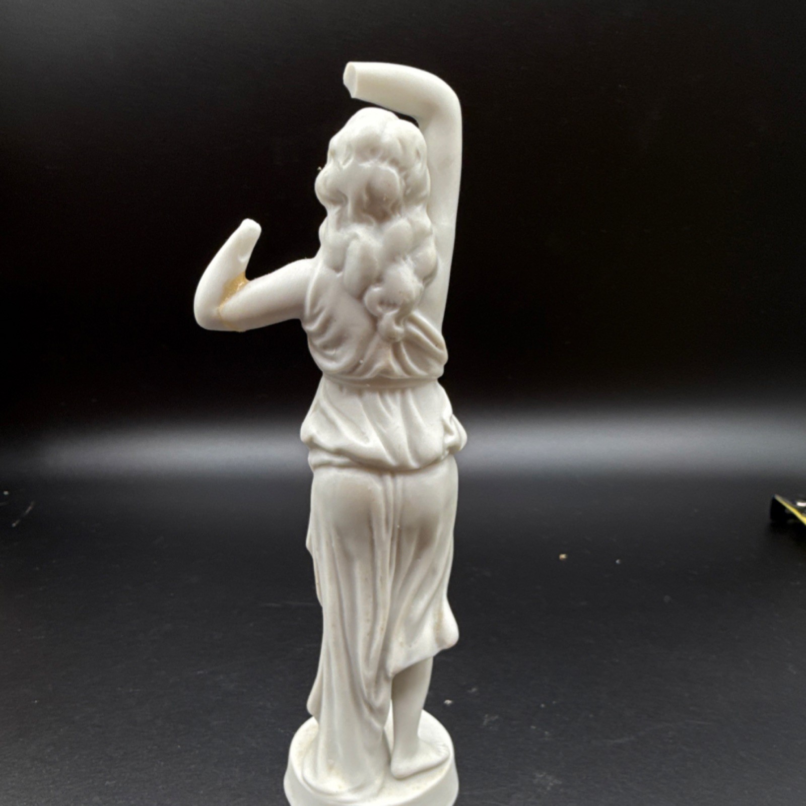 White porcelain figurine of a woman with carvings and matte finish, 6 in