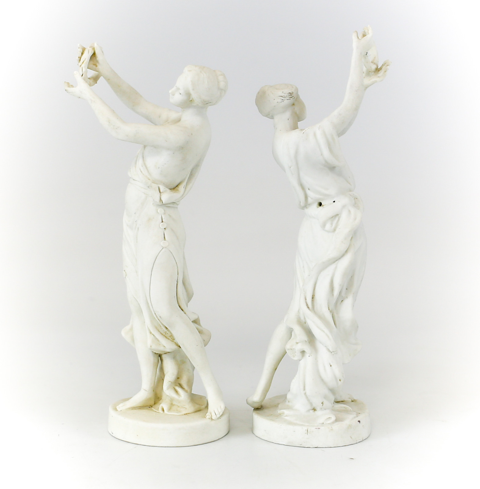 Pair of Sevres Bisque Porcelain Figurines of Women Deity Figures holding wreaths