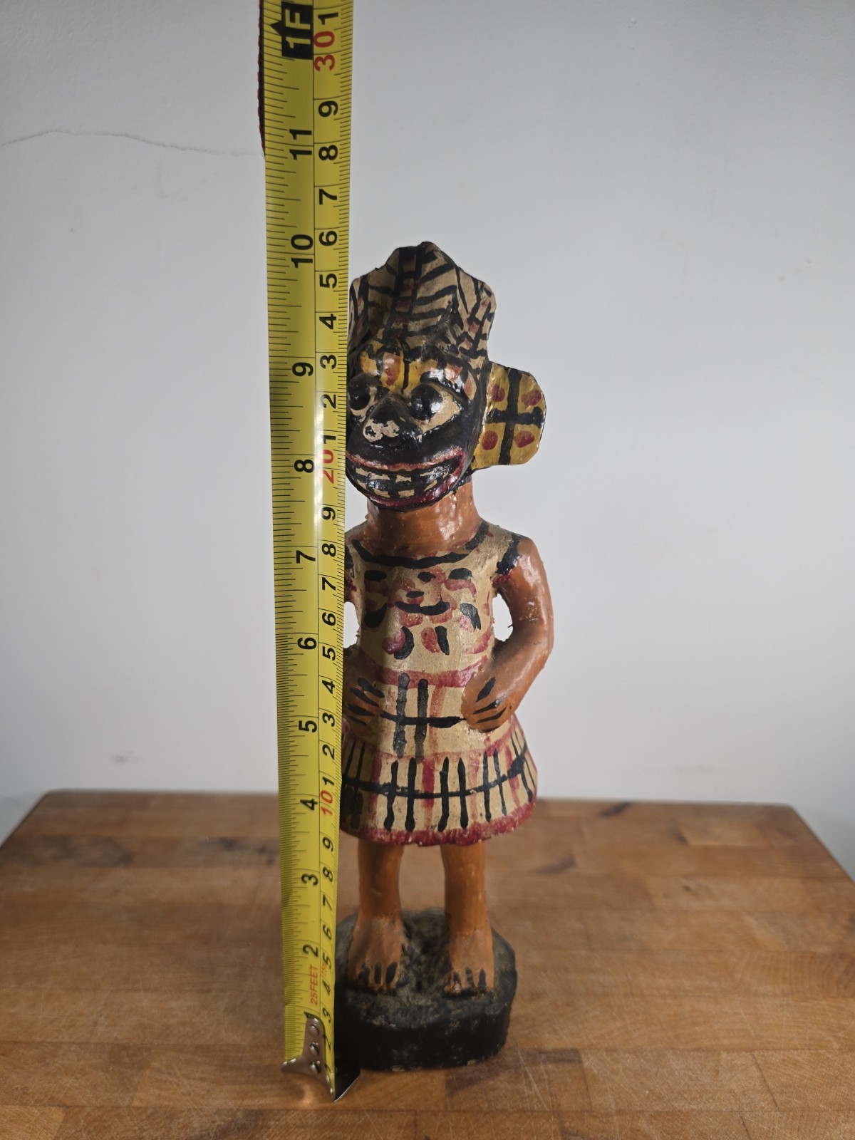 Folk art carved wood figure masked