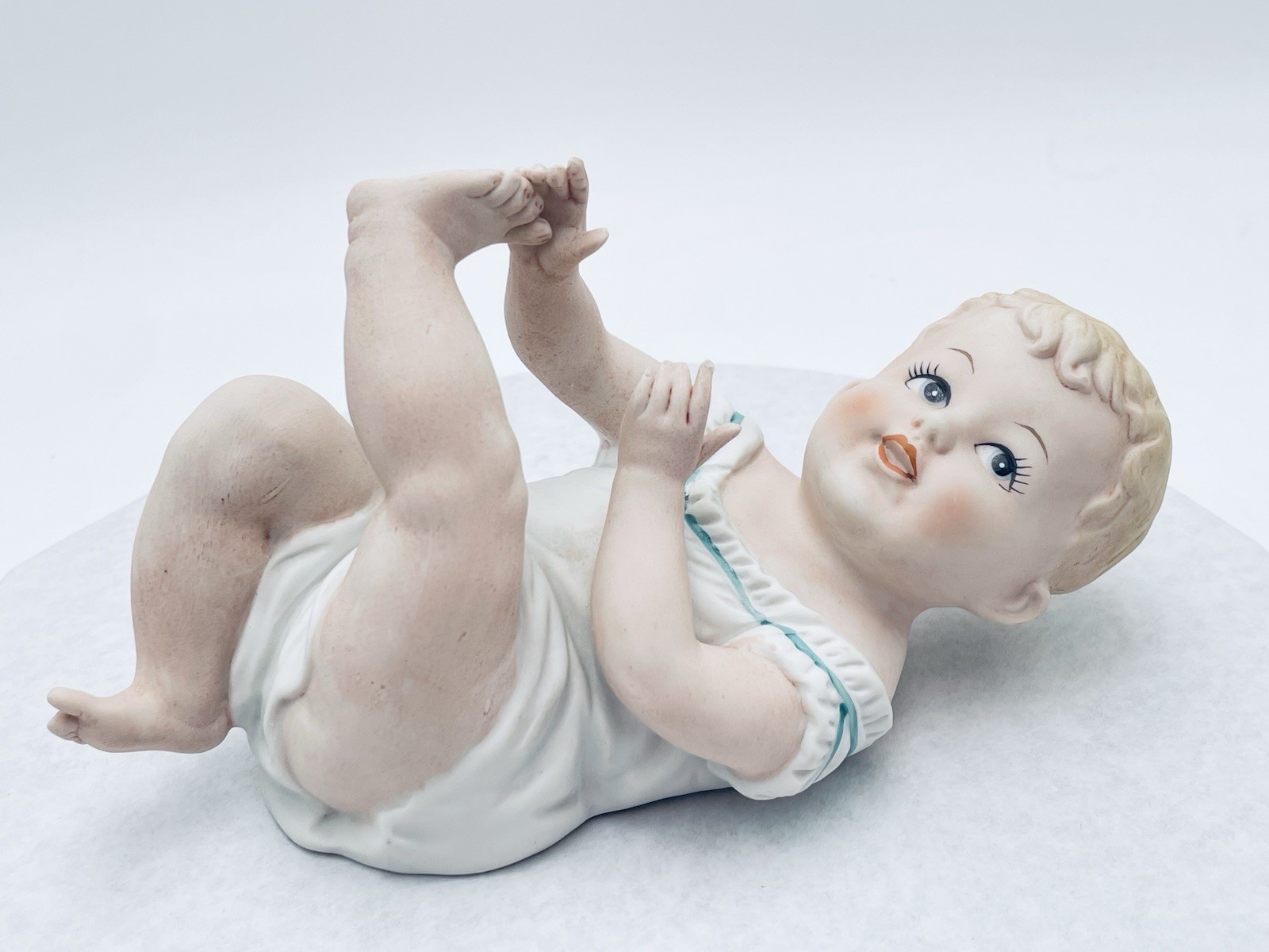 Vinyage Small PORCELAIN BISQUE PIANO BABY LAYING On BACK Blue accent