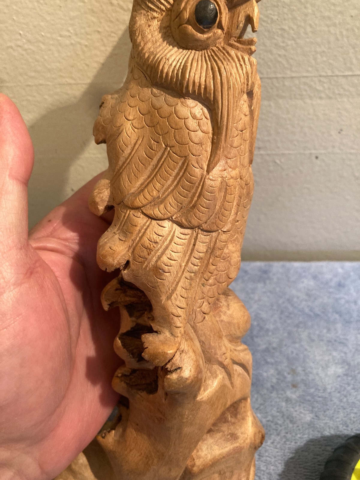 Owl bird statue hand carved from yellow natural wood with natural wood cracks
