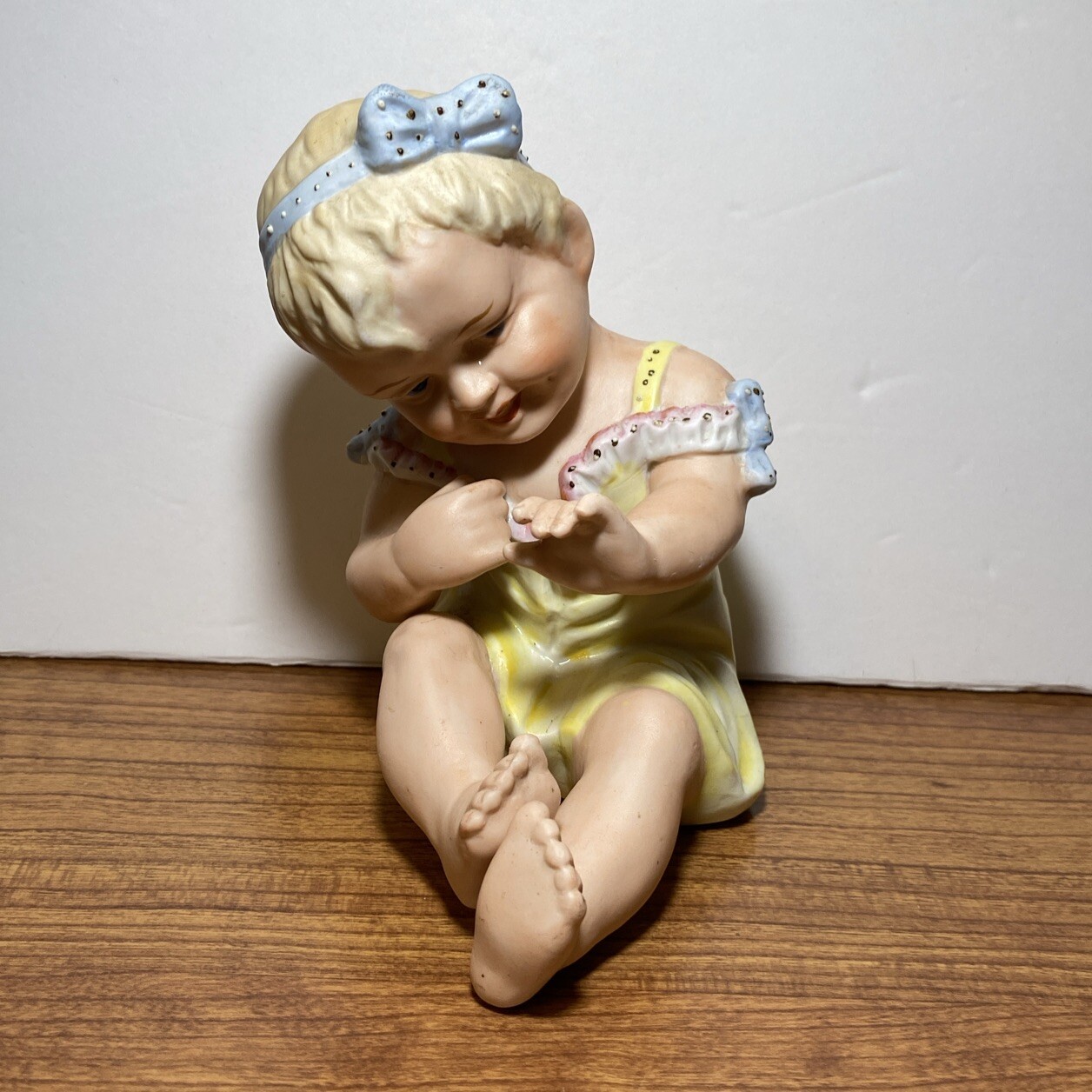 Porcelain Piano Baby Girl Figurine Hand Painted 5 x 3.5”