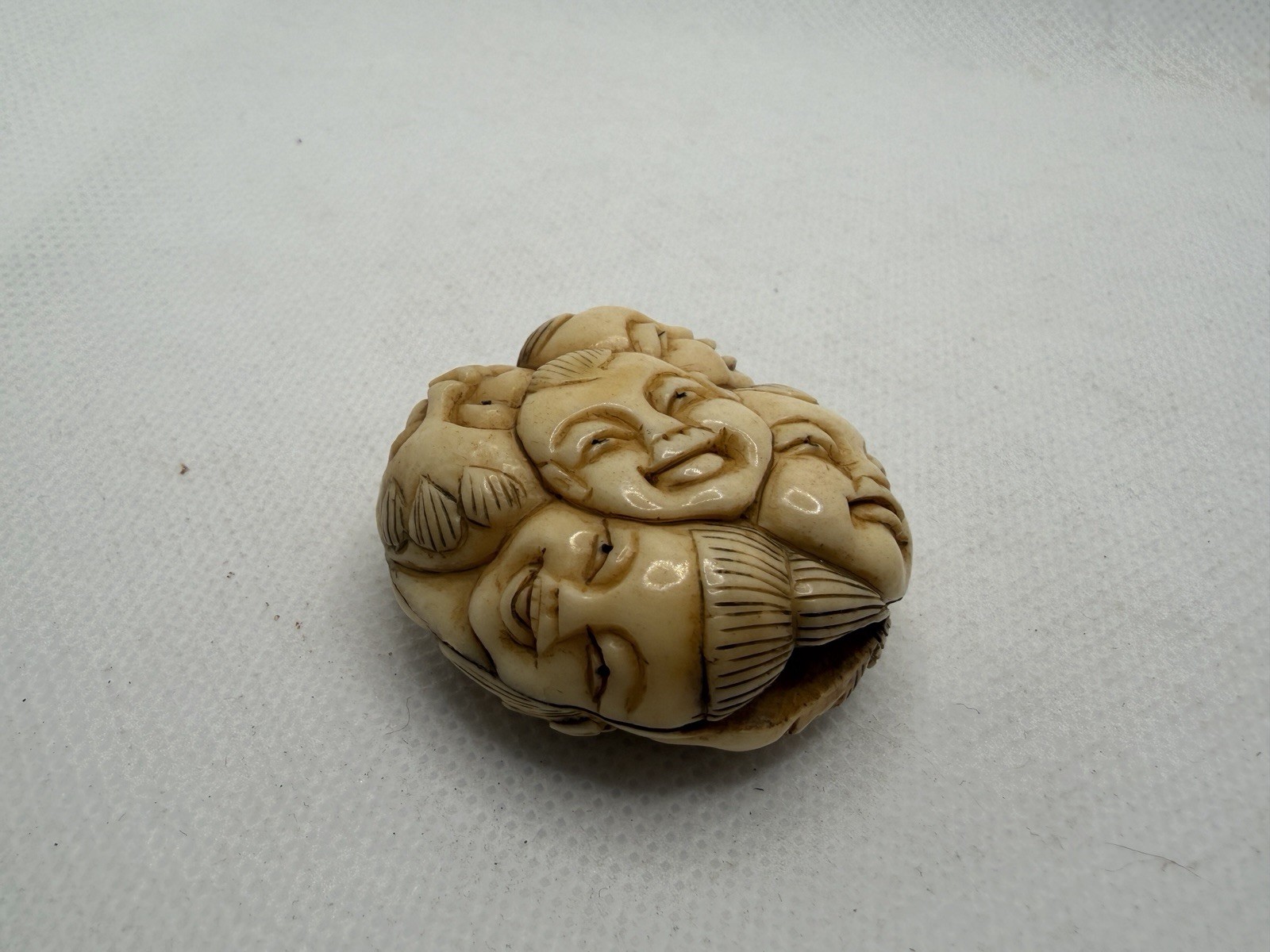 Japanese Carved Netsuke – Circular With Many Happy Faces And Geometric Shapes