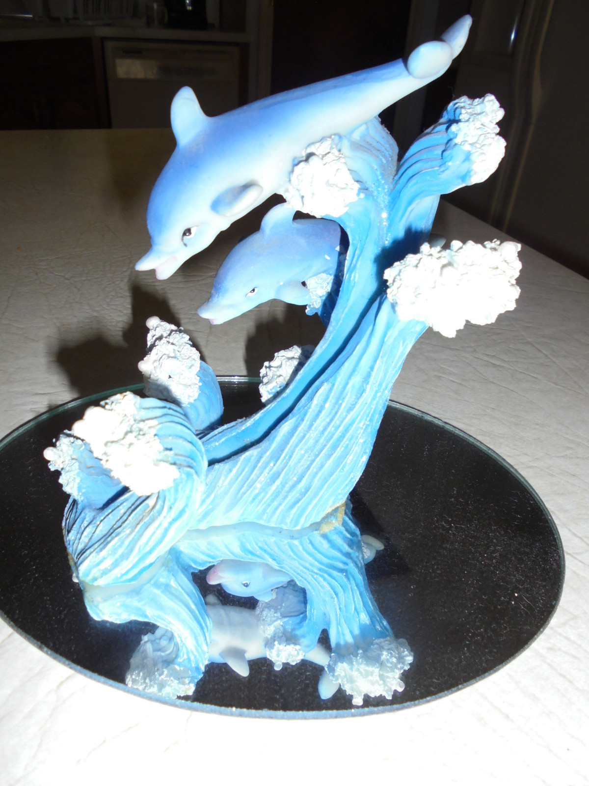 RESIN TWO DOLPHINS ON GLITTERED WAVES HOLDS A CLEAR MIRROR 8 IN TALL 5 1/2 IN W