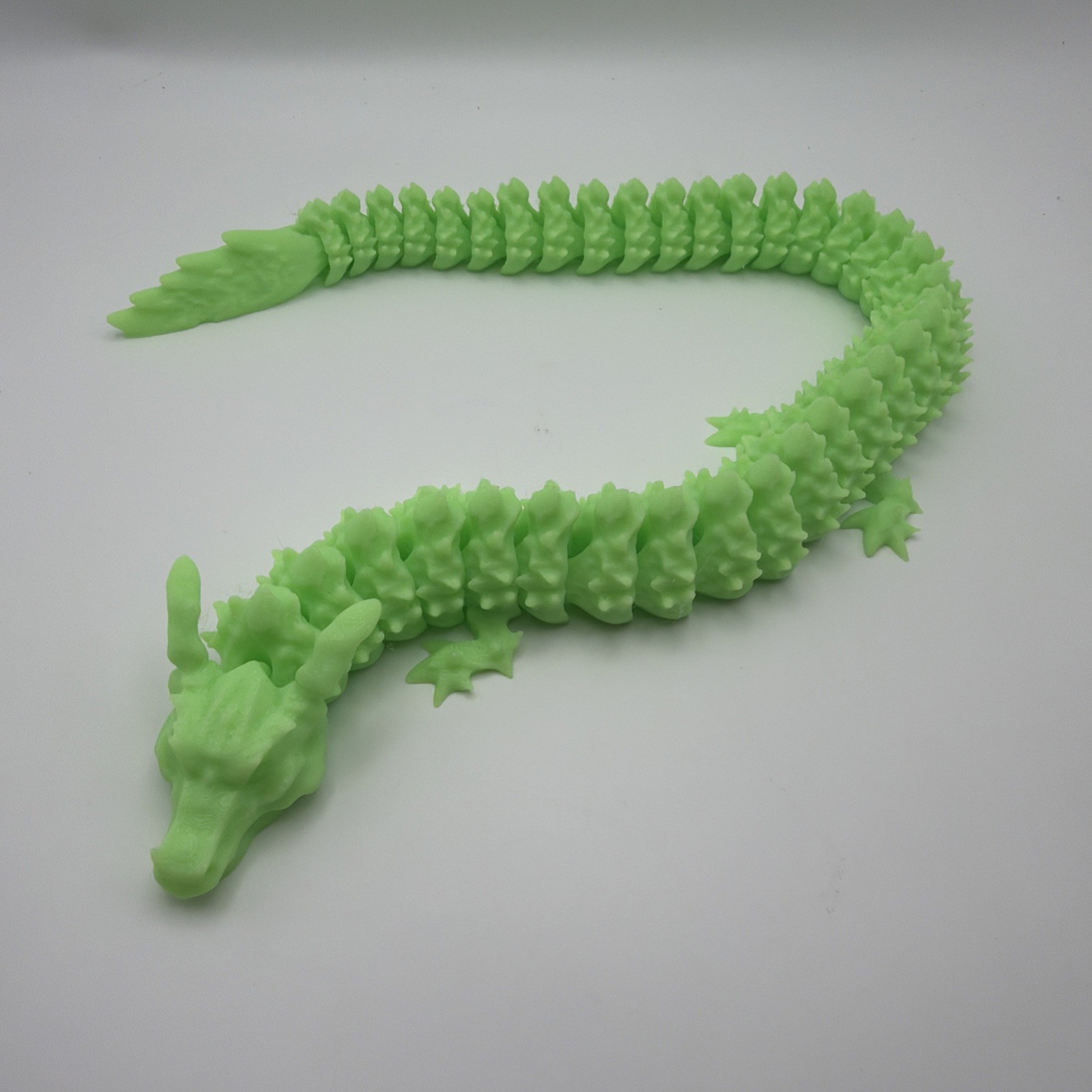 3d printed articulated dragon. Green, articulating Dragon. 16 Inches long.