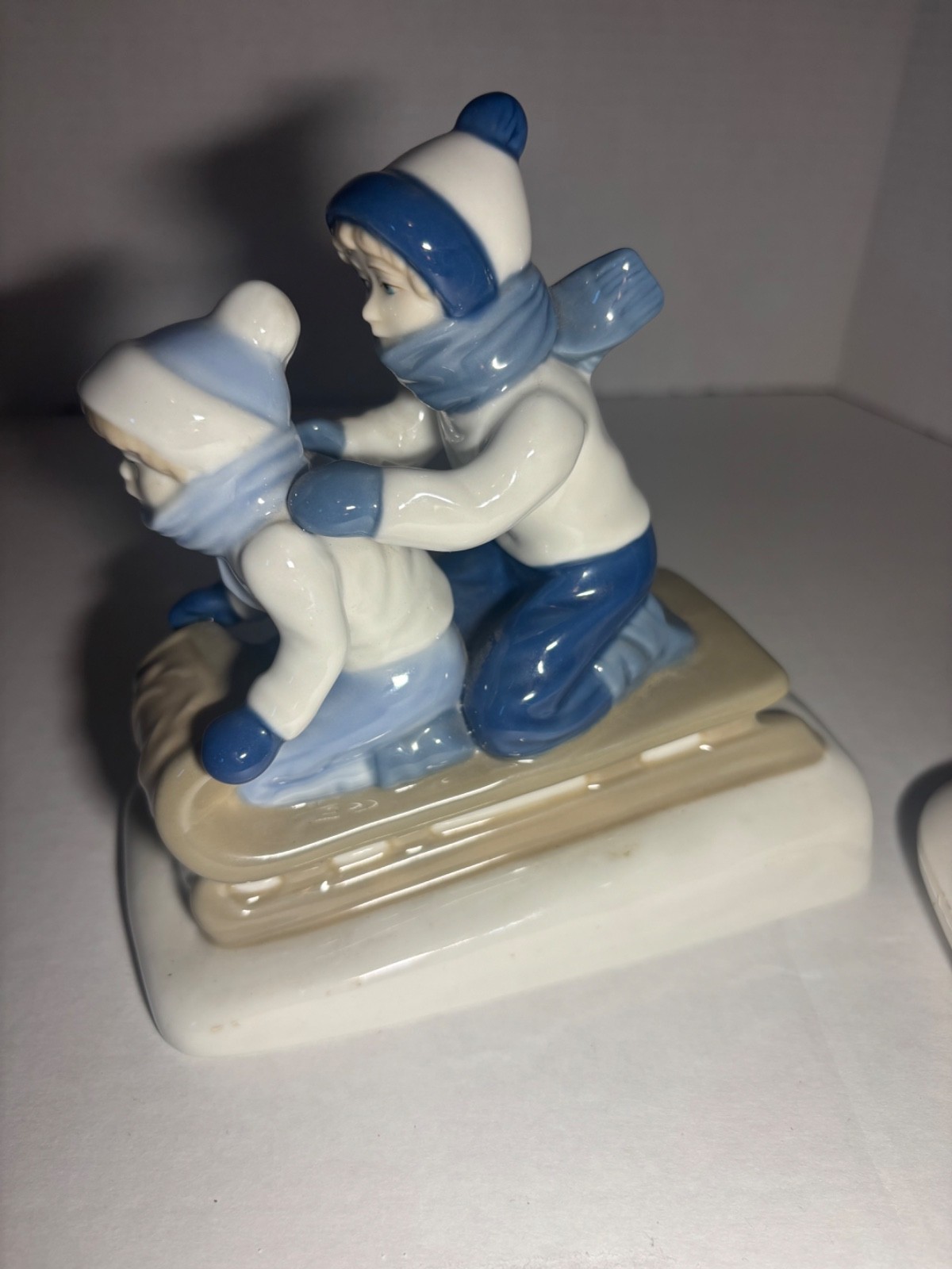 Children Sledding Figurine 6″L glazed ceramic gray & blue winter Christmas