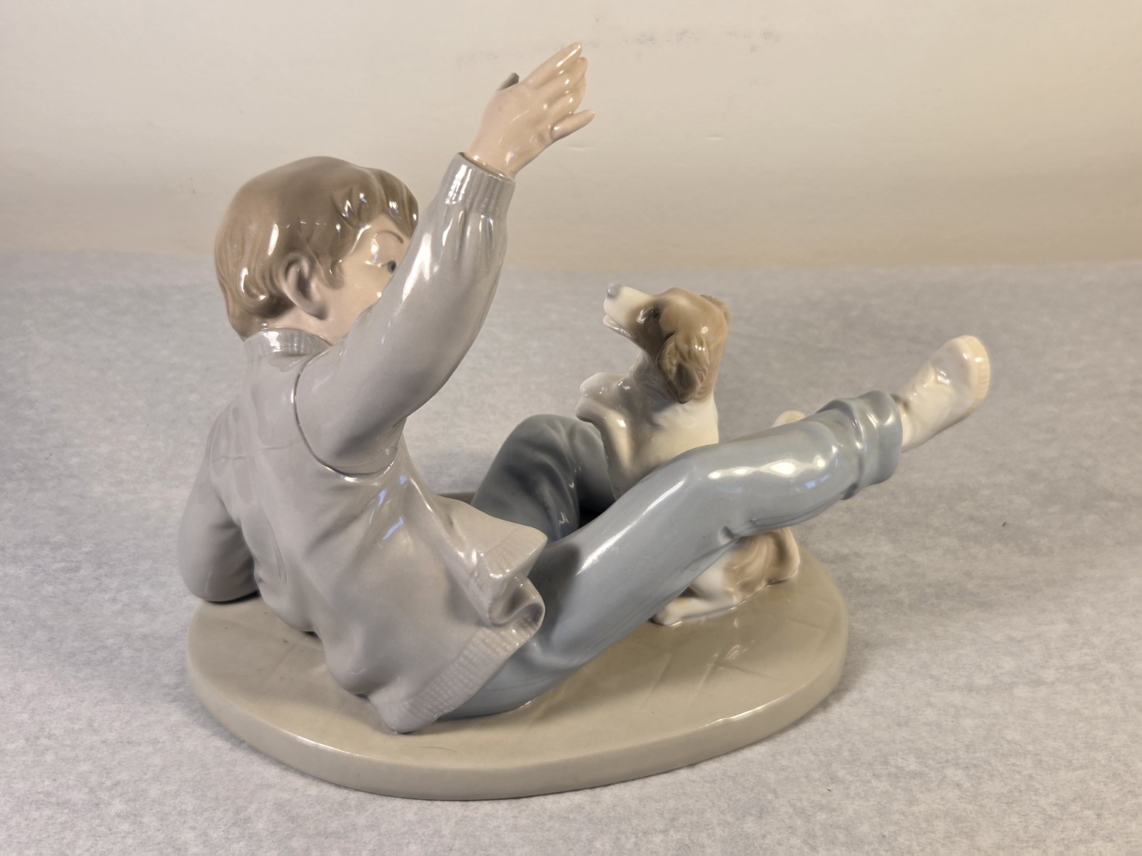 NAO by Lladro Figurine “Boy Playing with Dog” Model #0278 8″ Long x 6.5″ Tall
