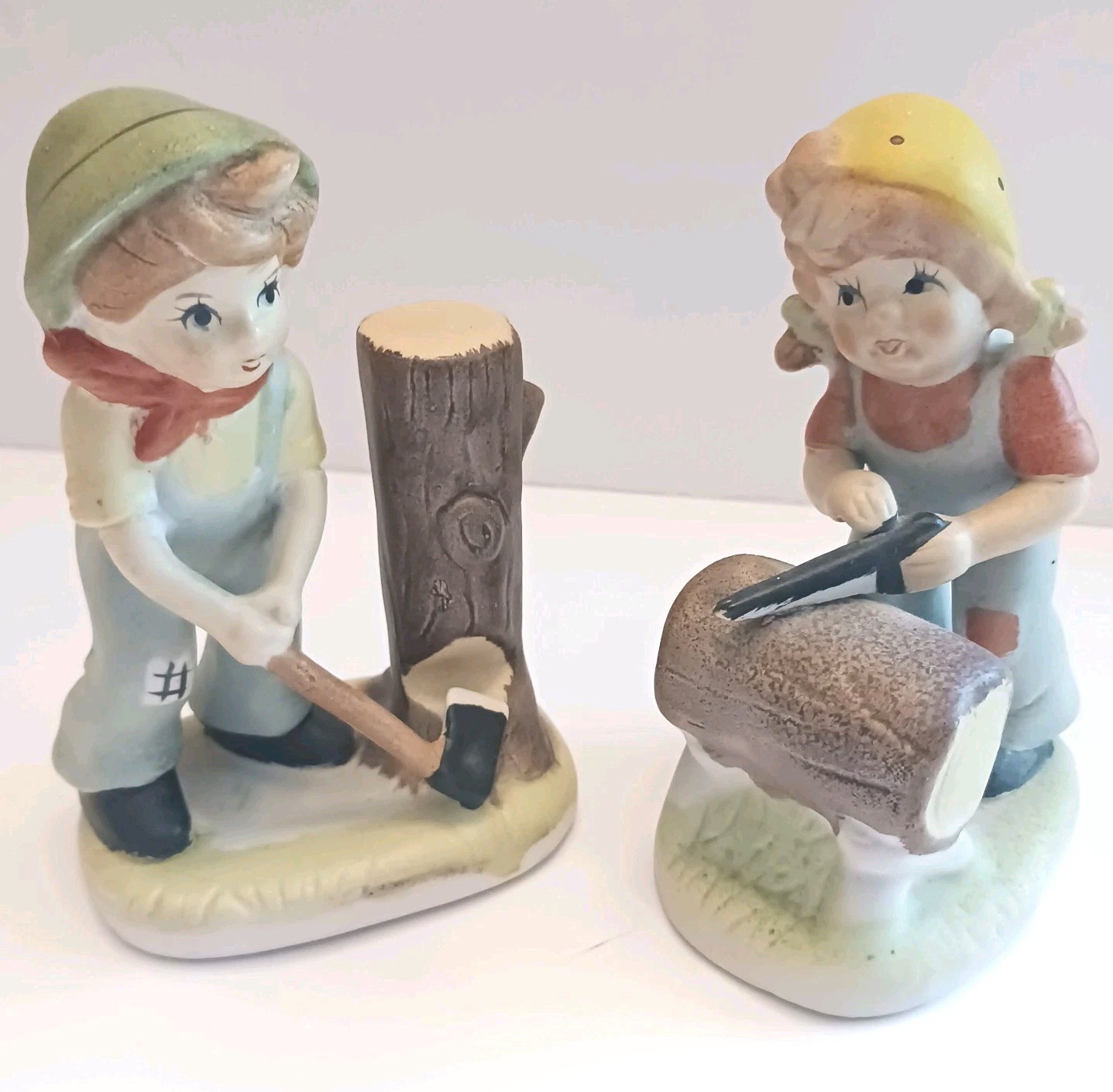 VTG Boy chopping wood 5″ And Girl sawing wood 4.5″ Figurines Porcelain Bisque