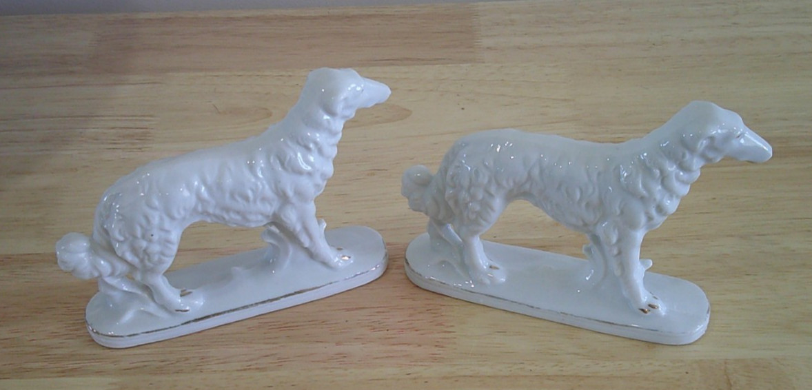 Pair of ceramic wolfhound figurines. 4 1/2 In. tall X 5 1/2 in. long