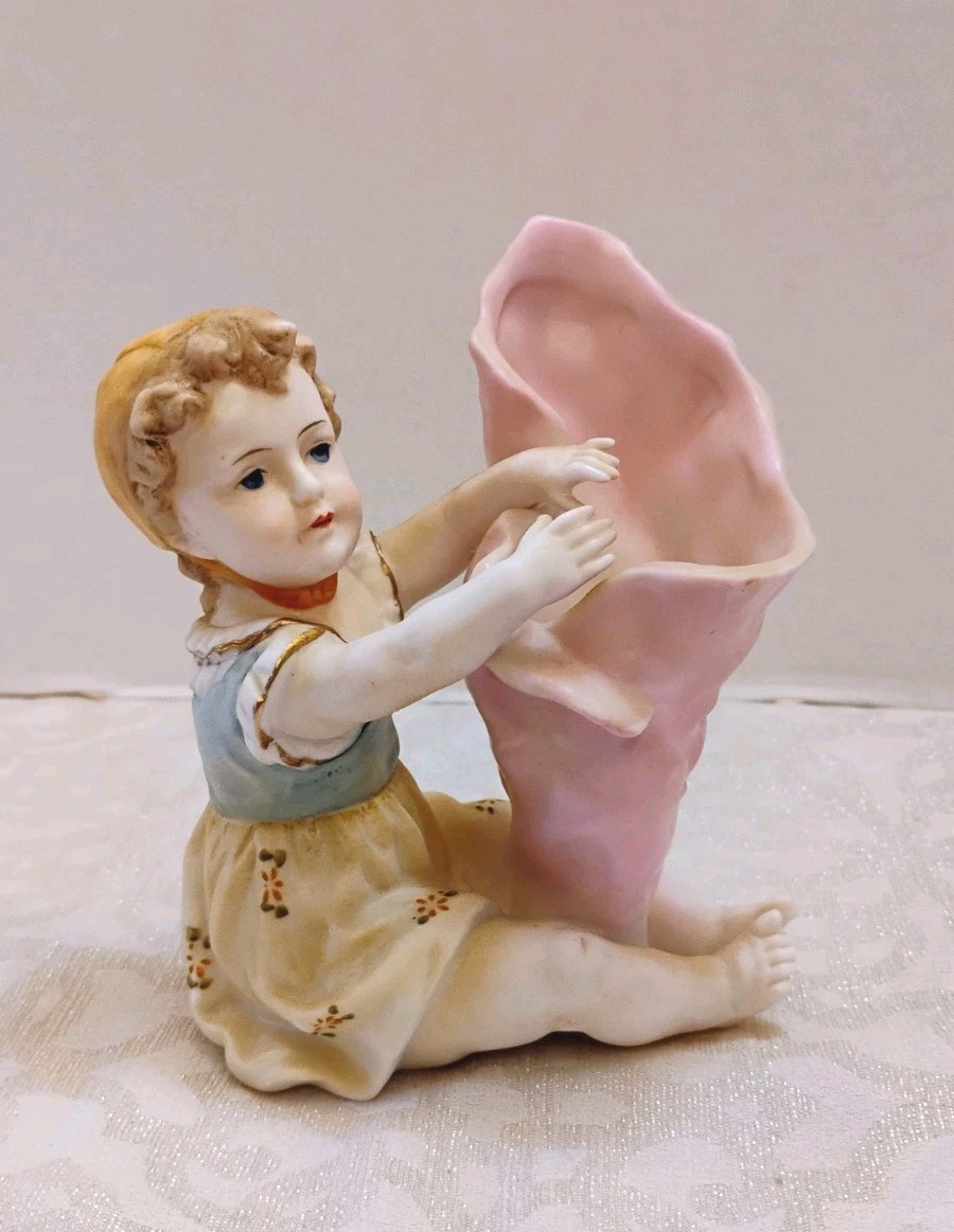 Vintage Bisque Piano Baby in Pastels Holding a Pink Petal Vase