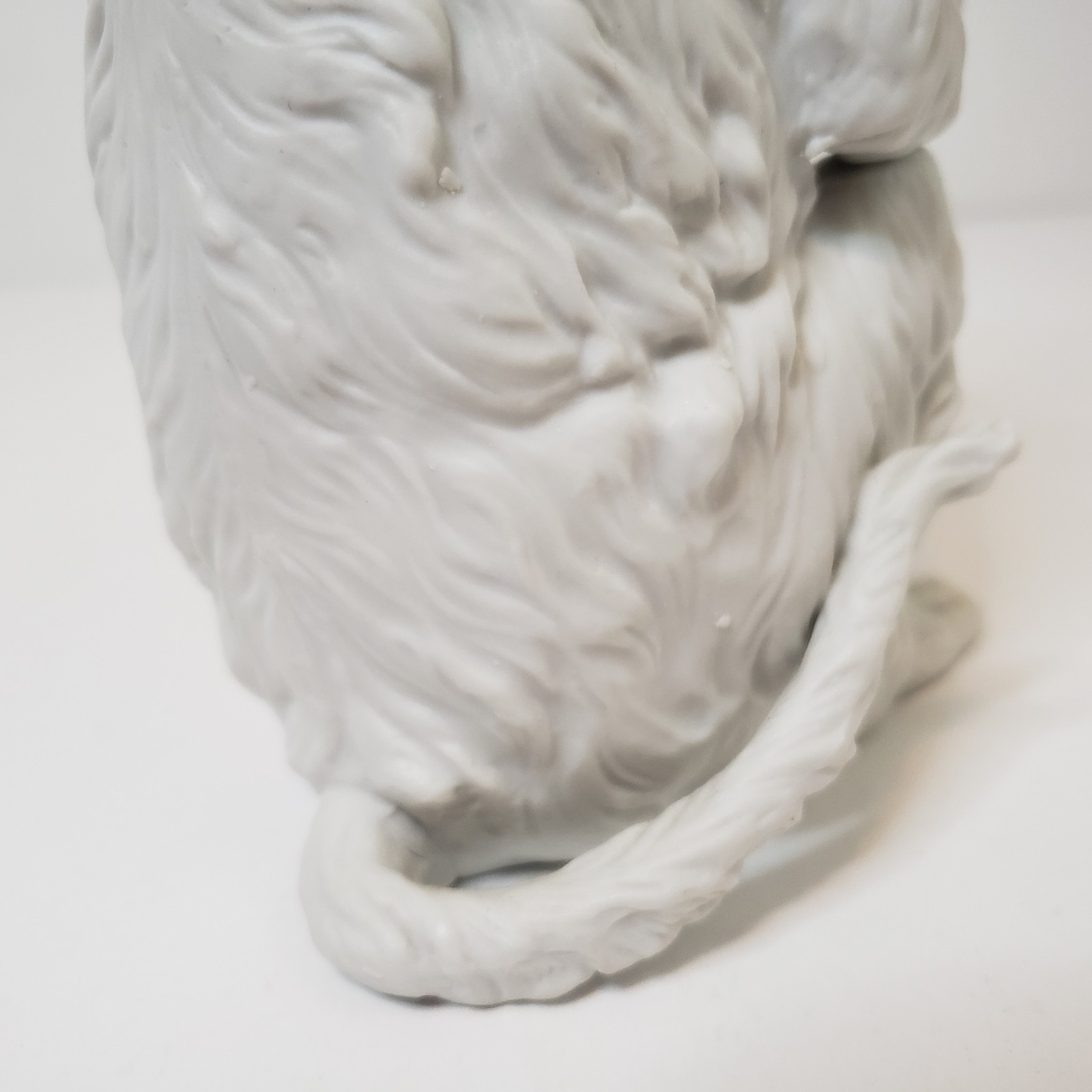 White Bisque Porcelain Sitting Monkey Holding Rock Figurine Vintage