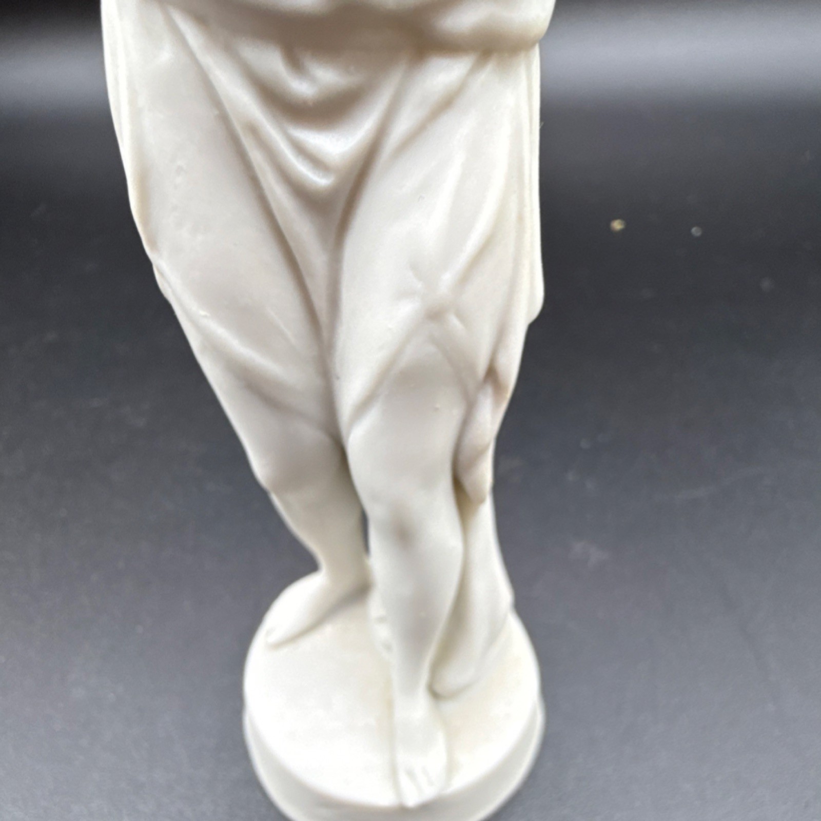 White porcelain figurine of a woman with carvings and matte finish, 6 in