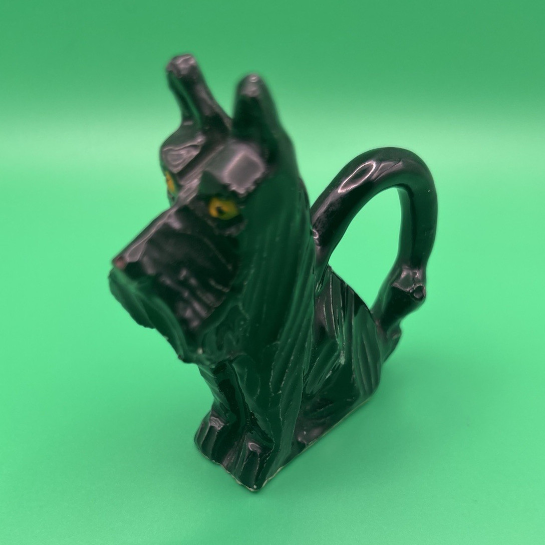 Vintage Black Glossy Ceramic Dog Figurine Yellow Eyes Small Handle Tail 3”