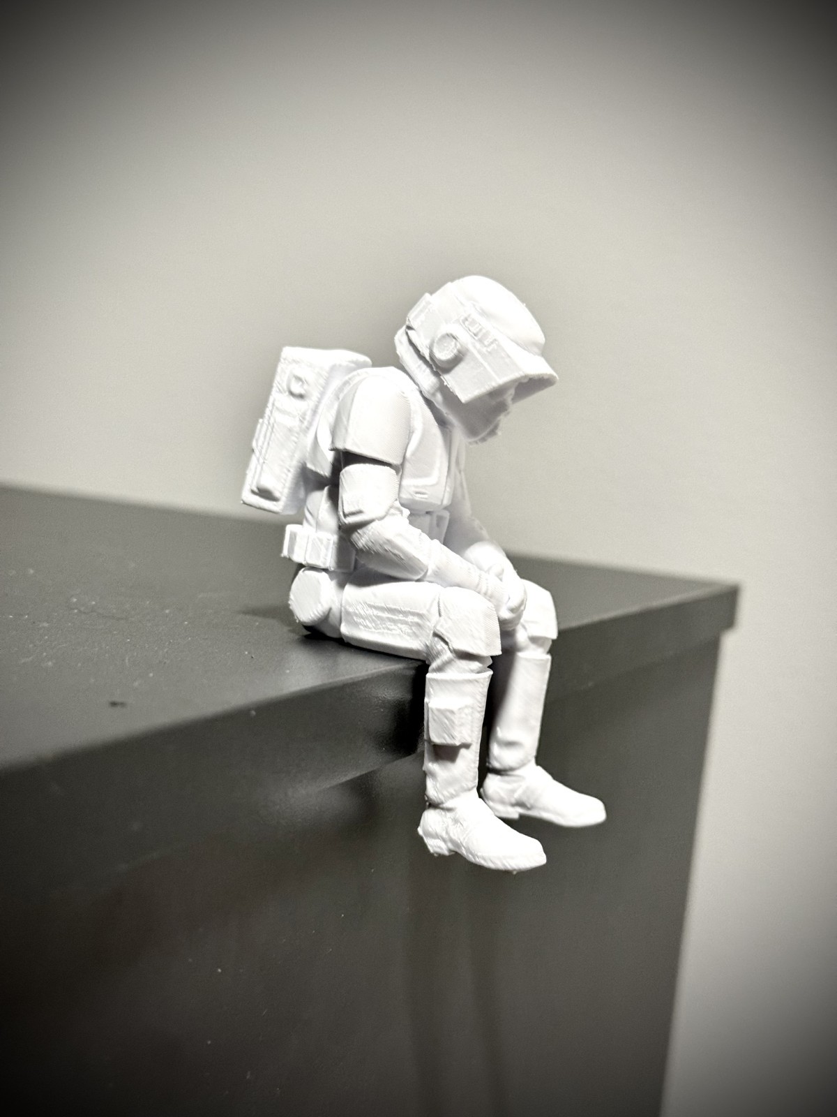 Seated scout trooper figurine