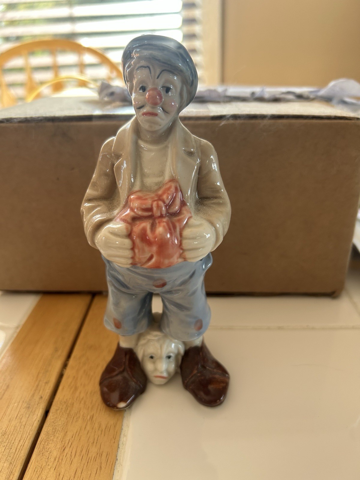 Ceramic Boy Holding Gift Figurine Hand Painted Glazed Blue Beige Brown Red