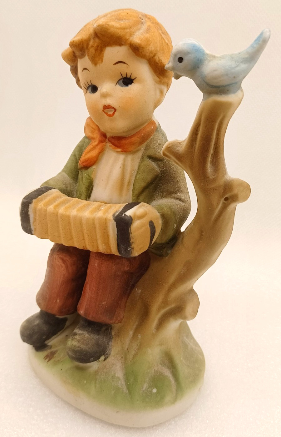 VTG YOUNG BOY PLAYING AN ACCORDIAN TO A BLUE BIRD ON A BRANCH-4 3/4″ TALL