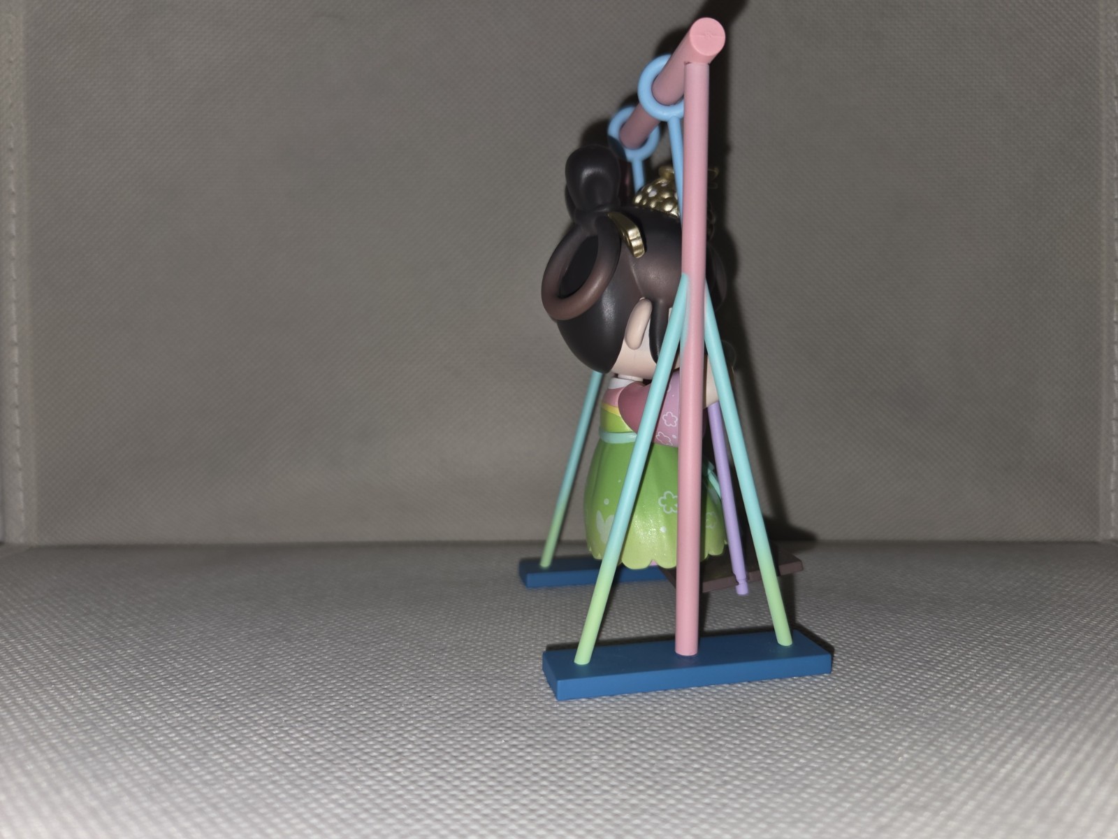 Girl Figurine on Swing, Multicolor Painted Plastic 3D Effect, Animation Theme