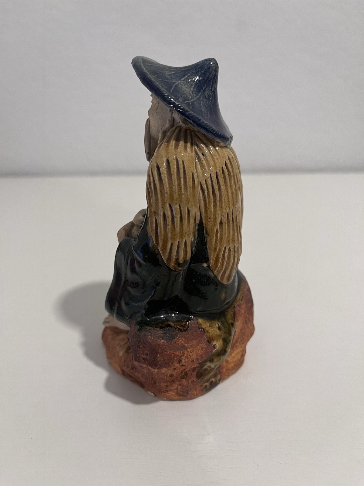 Vintage Chinese Ceramic Seated Mudman Figurine w/ Blue Hat Holding Pot