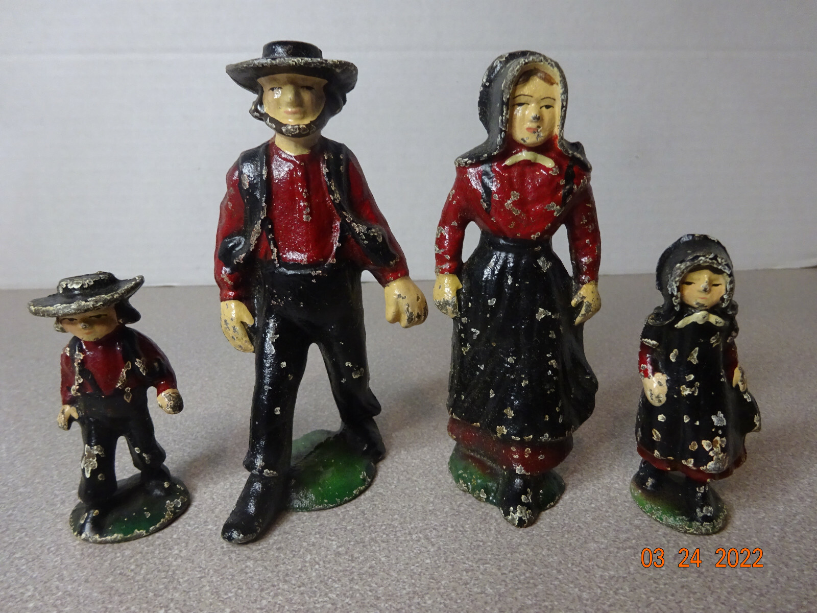 Cast Iron Amish Family of Four Dressed in Black & Red Vintage