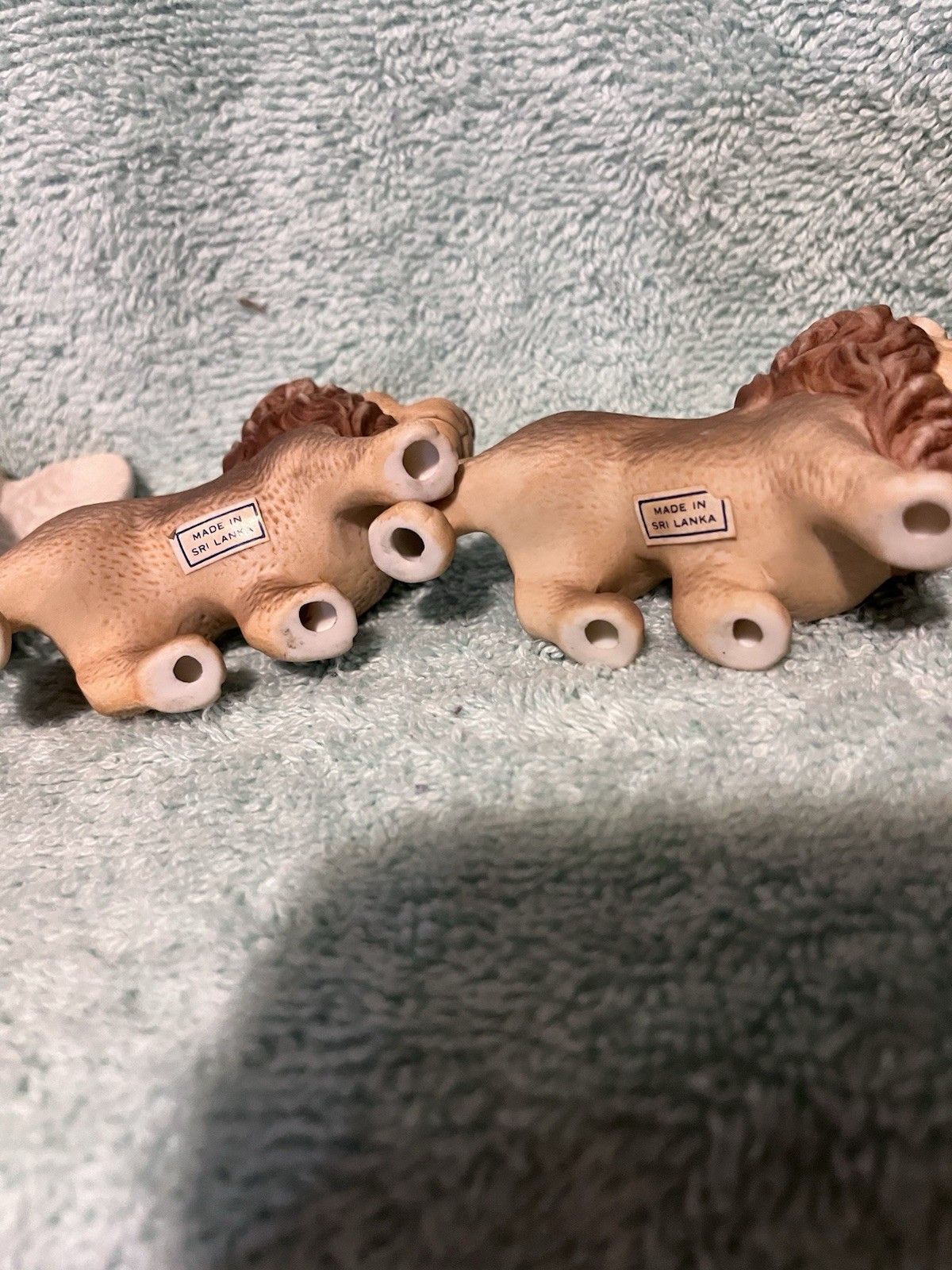A Vintage Bisque Angle Figurine With Two Small Ceramic Lions