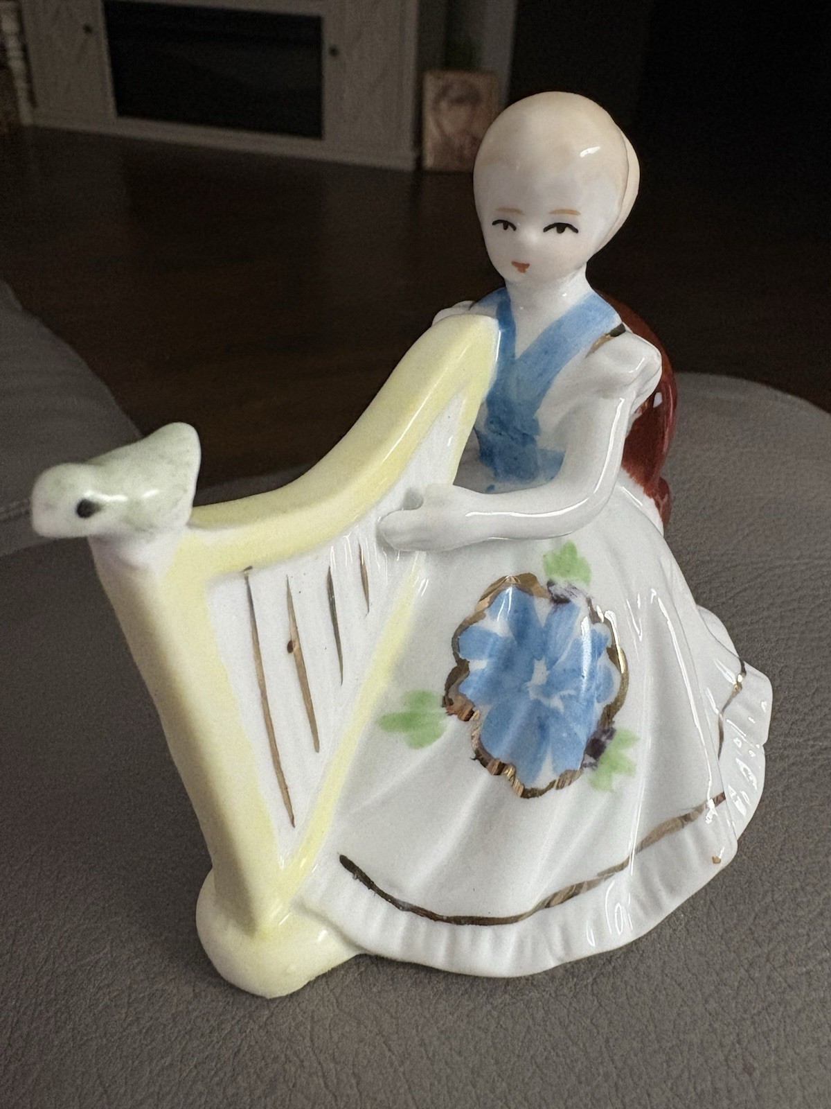 vintage porcelain figurine of a woman playing a harp