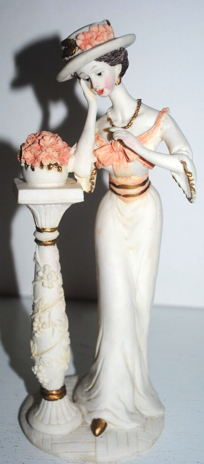 Elegant decorative figurine, 8.5″, woman next to flower stand, Gatsby-style