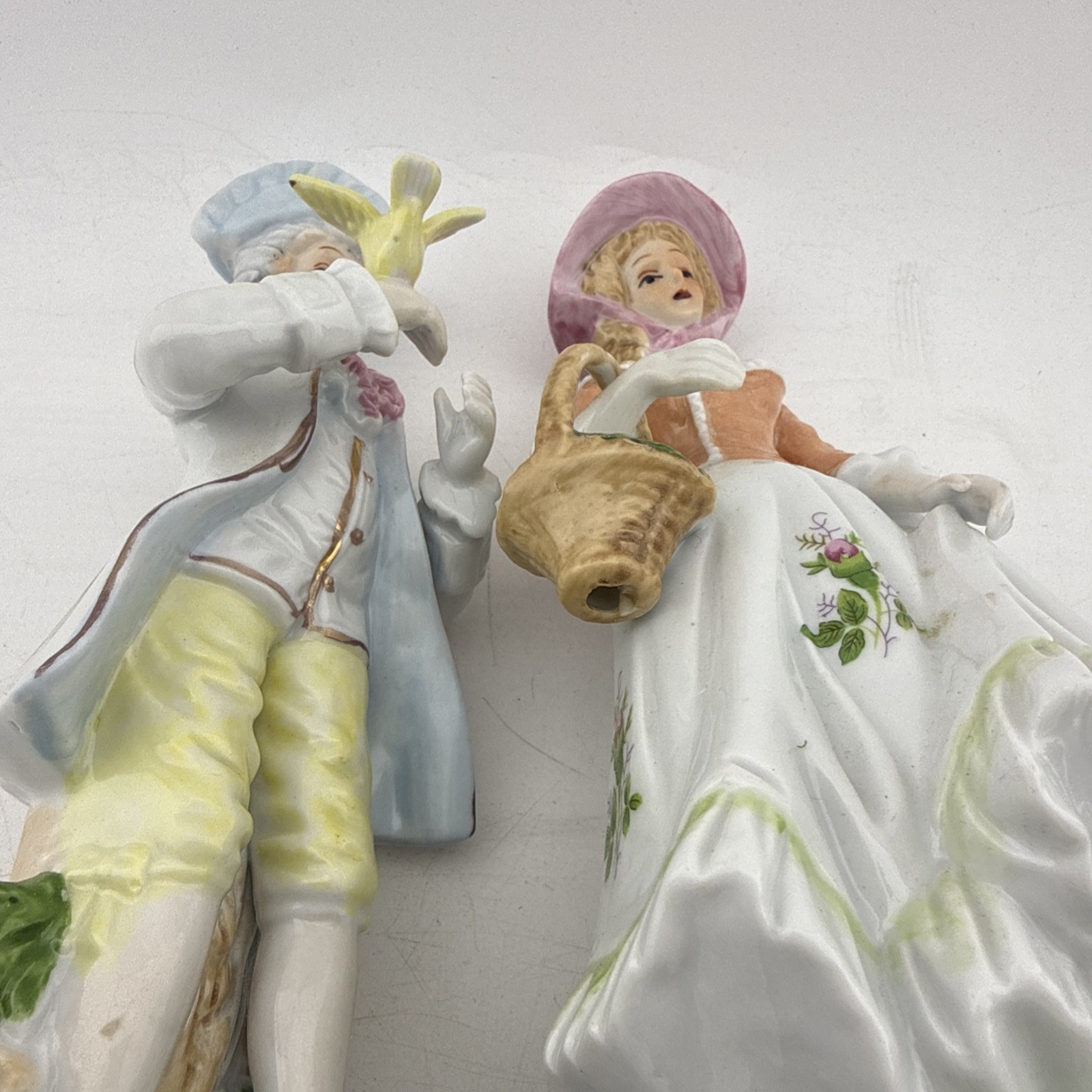 Vintage Colonial Porcelain Couple Figurines Man Bird Woman Basket