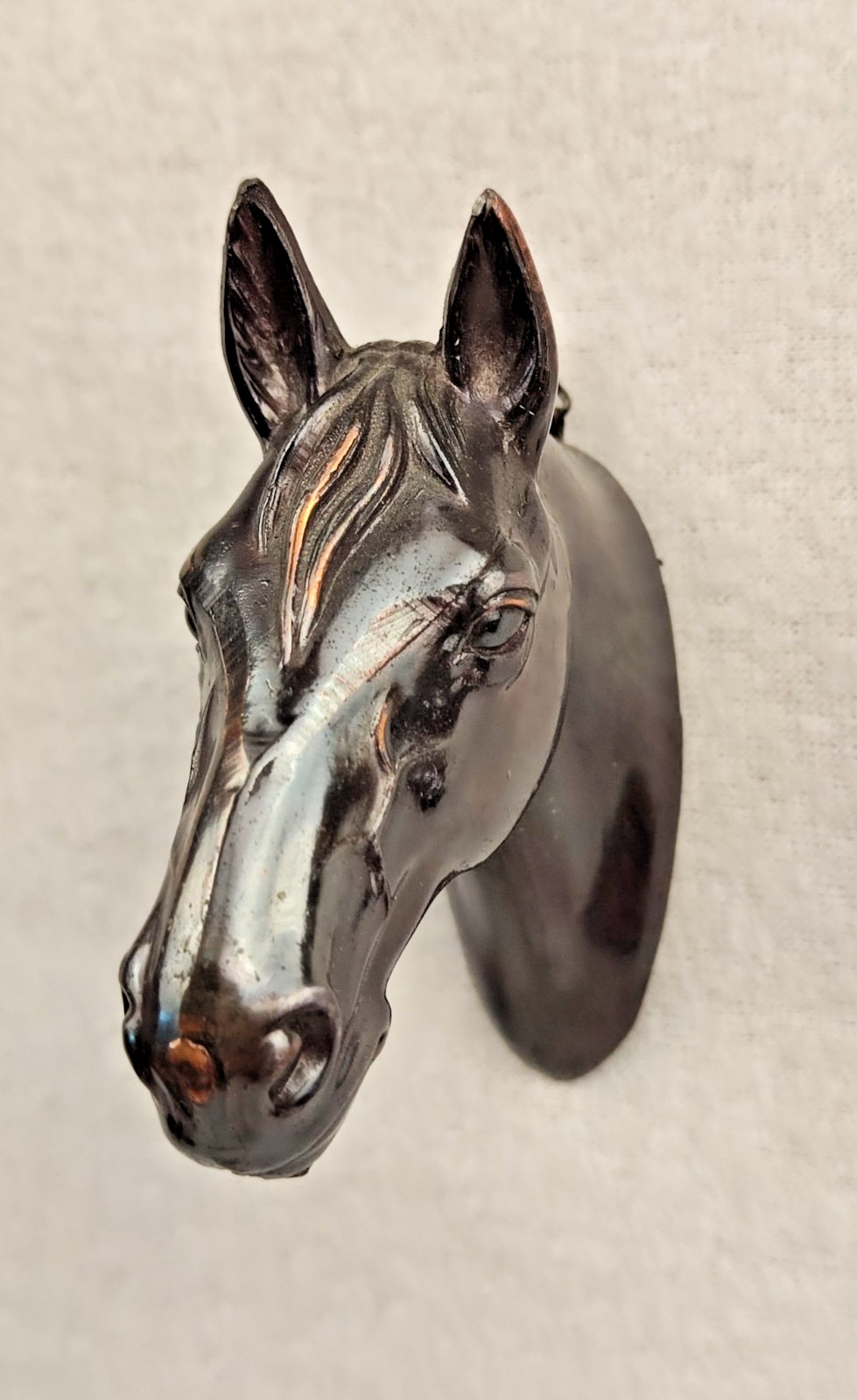 A decorative wall sculpture in the shape of a horse’s head