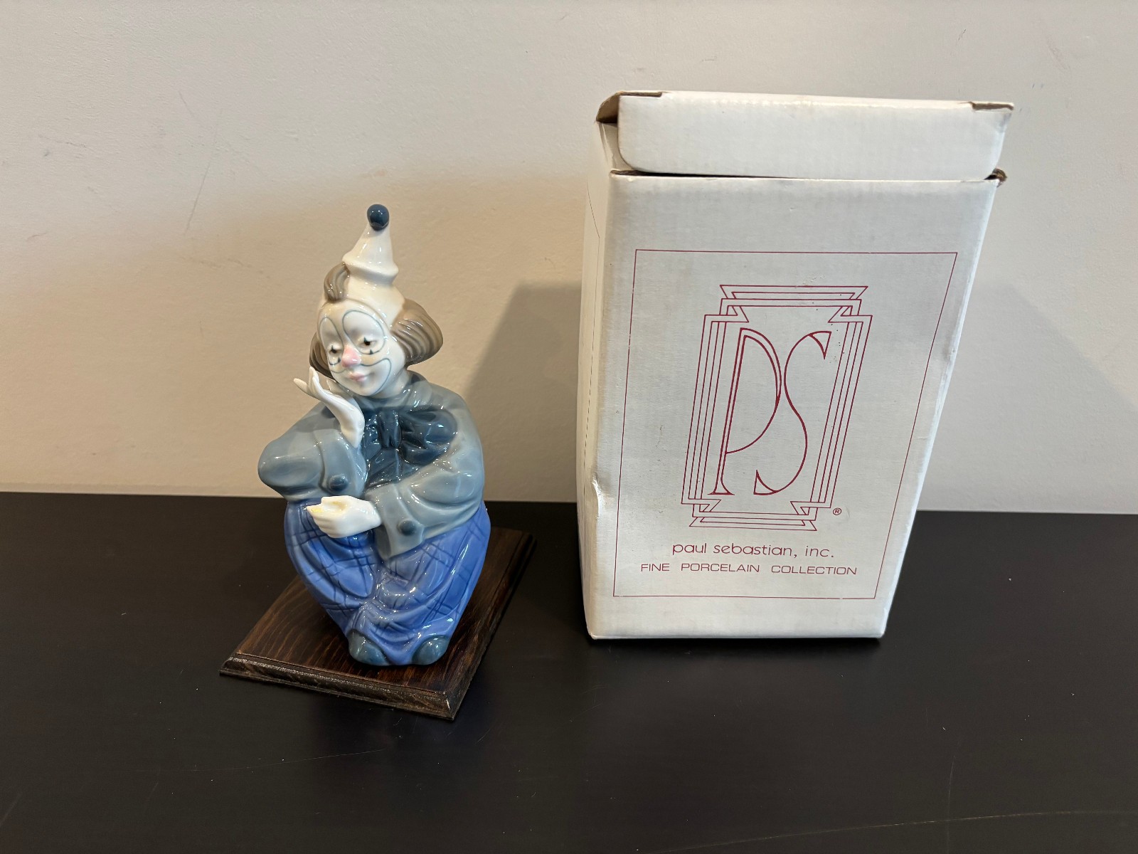 Paul Sebastian porcelain clown sitting wearing blue pants