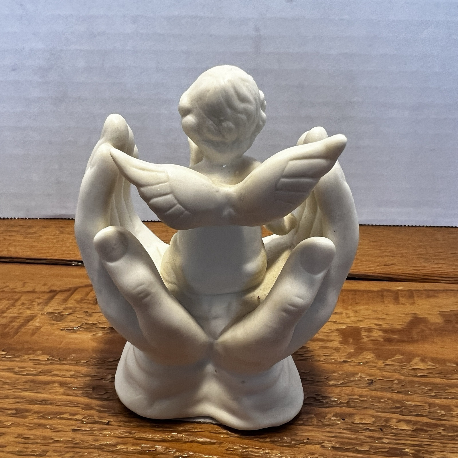 Vintage White Porcelain Figurine~Cherub Angel Sitting in Praying Hands~BEAUTIFUL