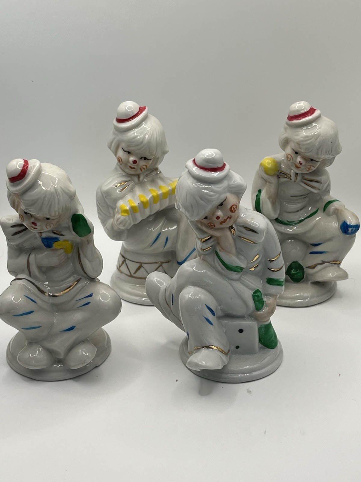 Set of 4 Glossy White Ceramic Circus Clown Figurines with Painted Accents