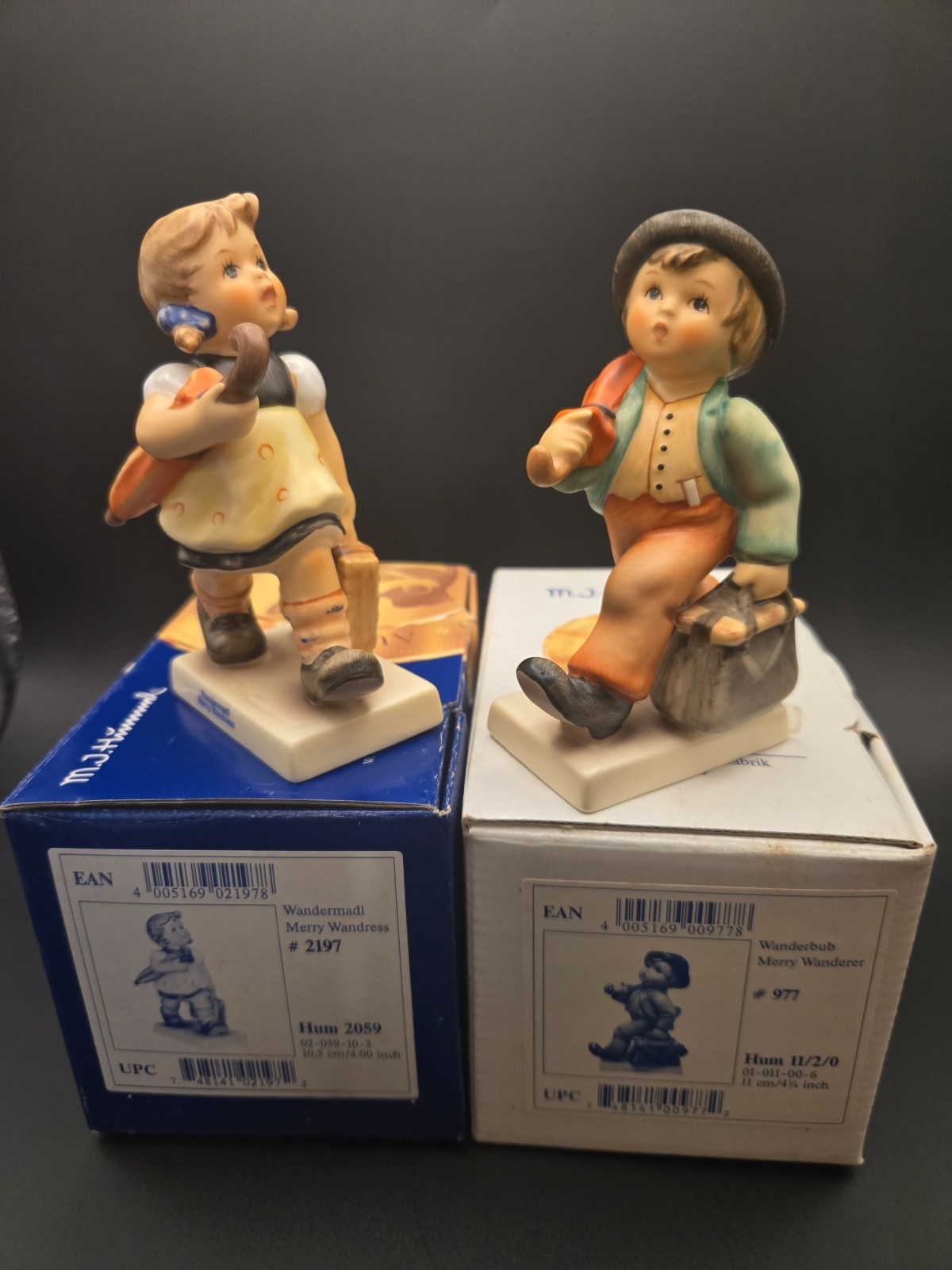 Hummel Merry Wandress 1st Issue signed & Merry Wanderer Commemorative – set of 2