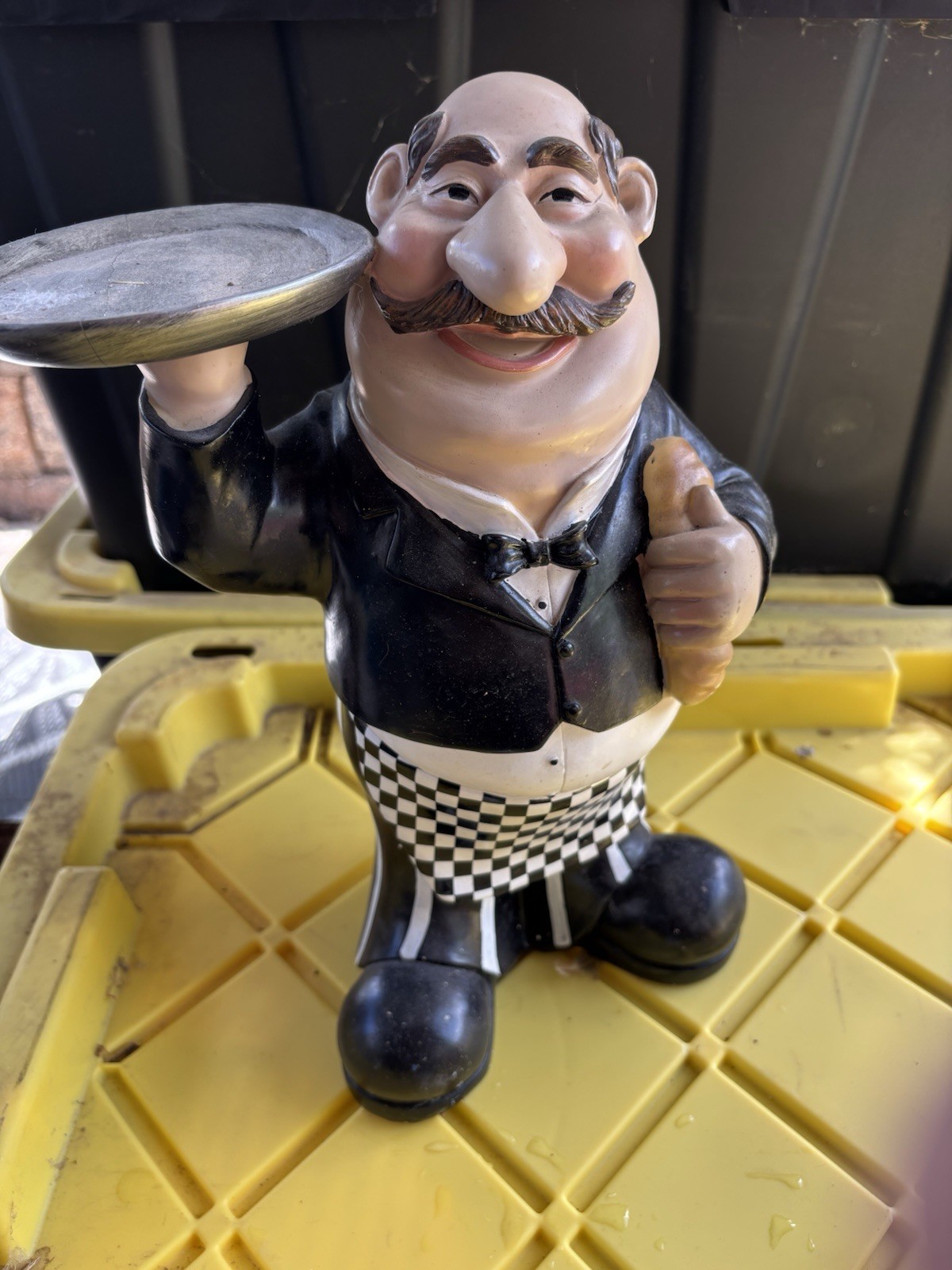 Resin figurine of a waiter or butler character holding a serving tray