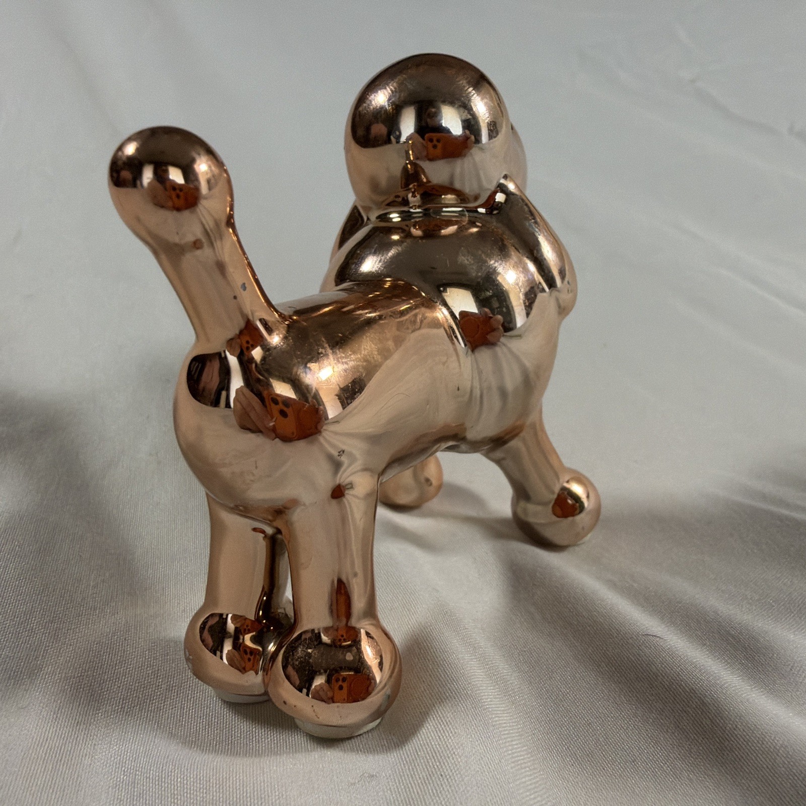 Ceramic metallic rose gold balloon dog figurine.