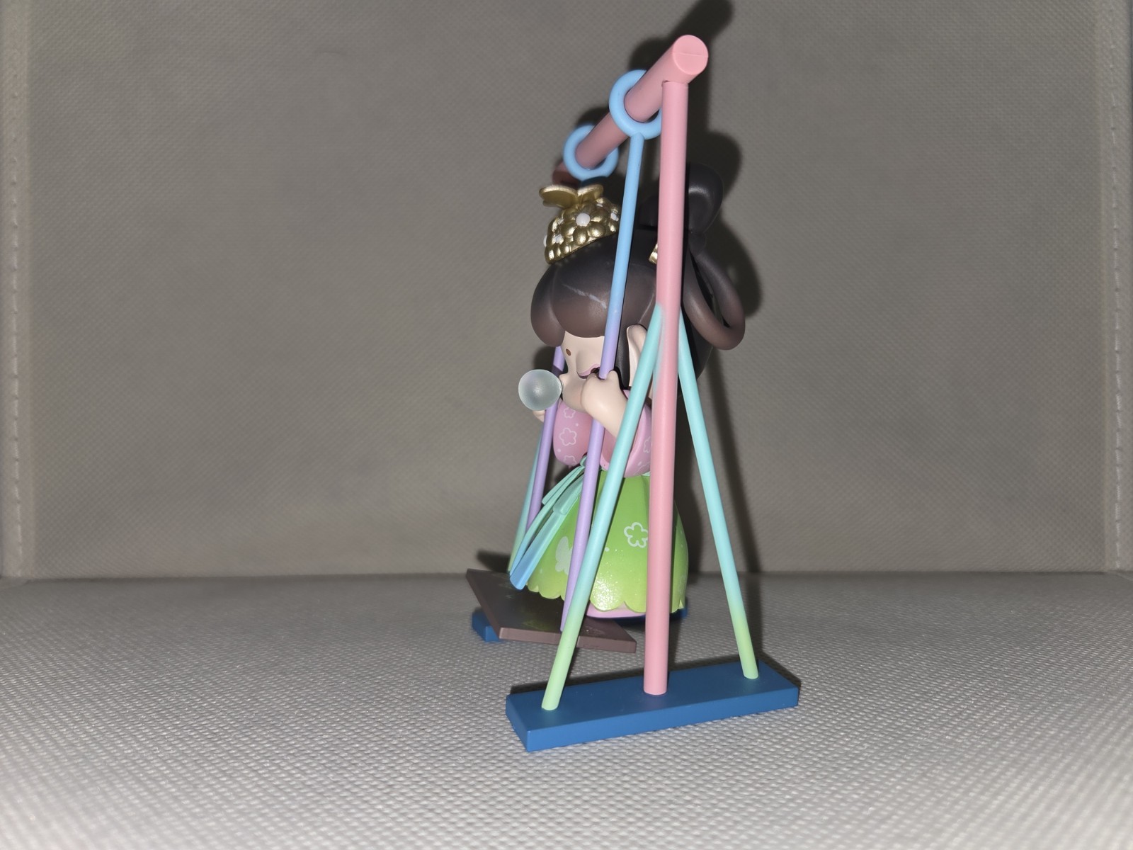 Girl Figurine on Swing, Multicolor Painted Plastic 3D Effect, Animation Theme