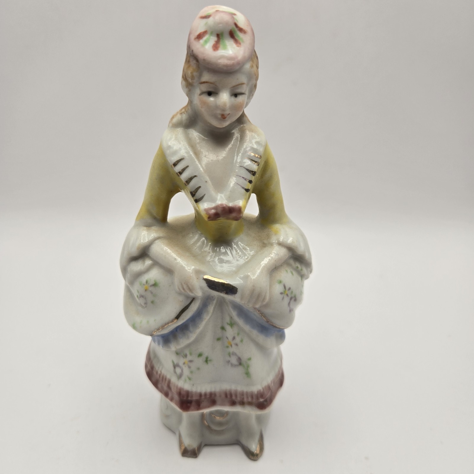 porcelain figurine woman dressed in colonial-era attire. Made In Occupied Japan