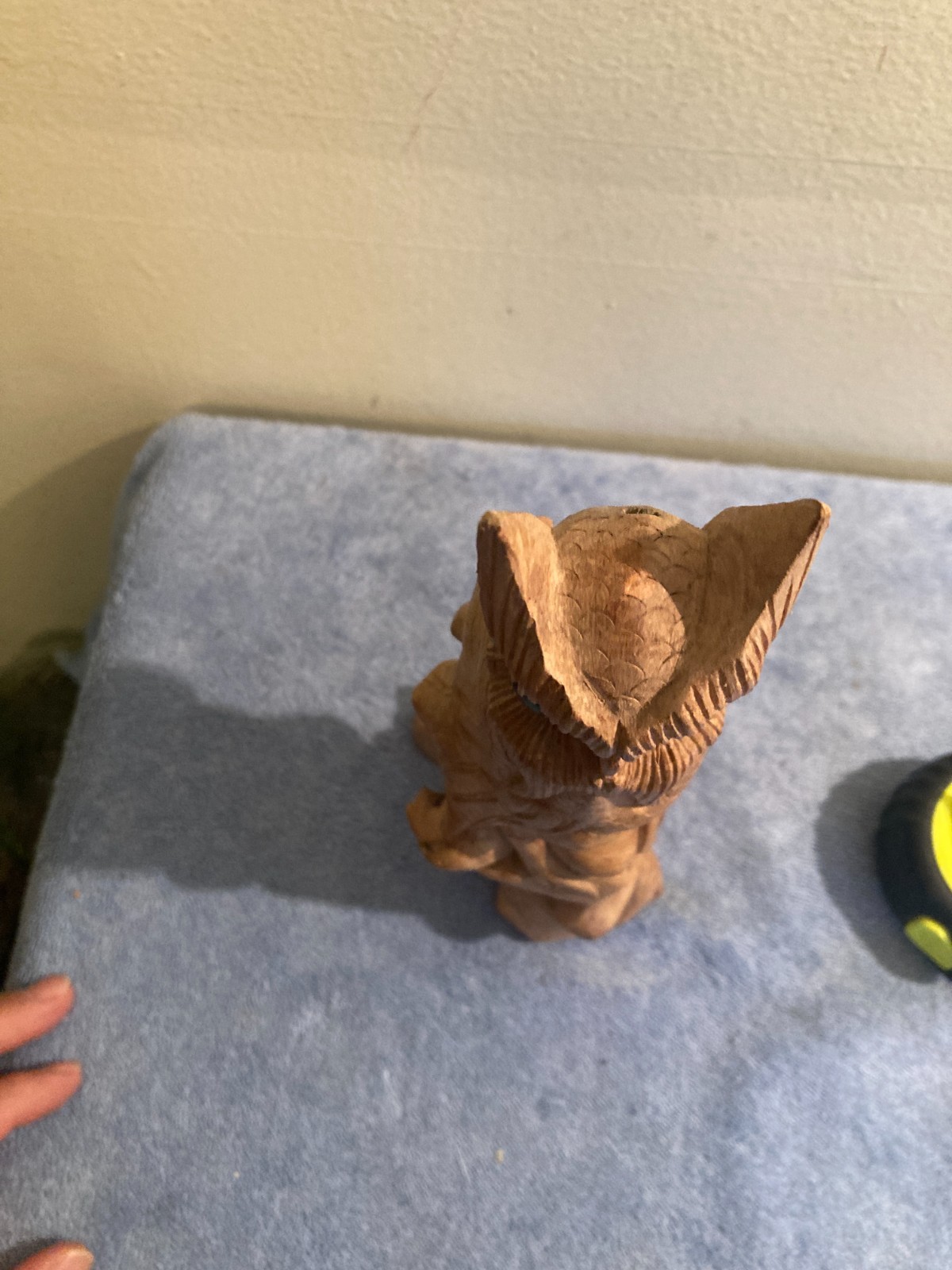 Owl bird statue hand carved from yellow natural wood with natural wood cracks