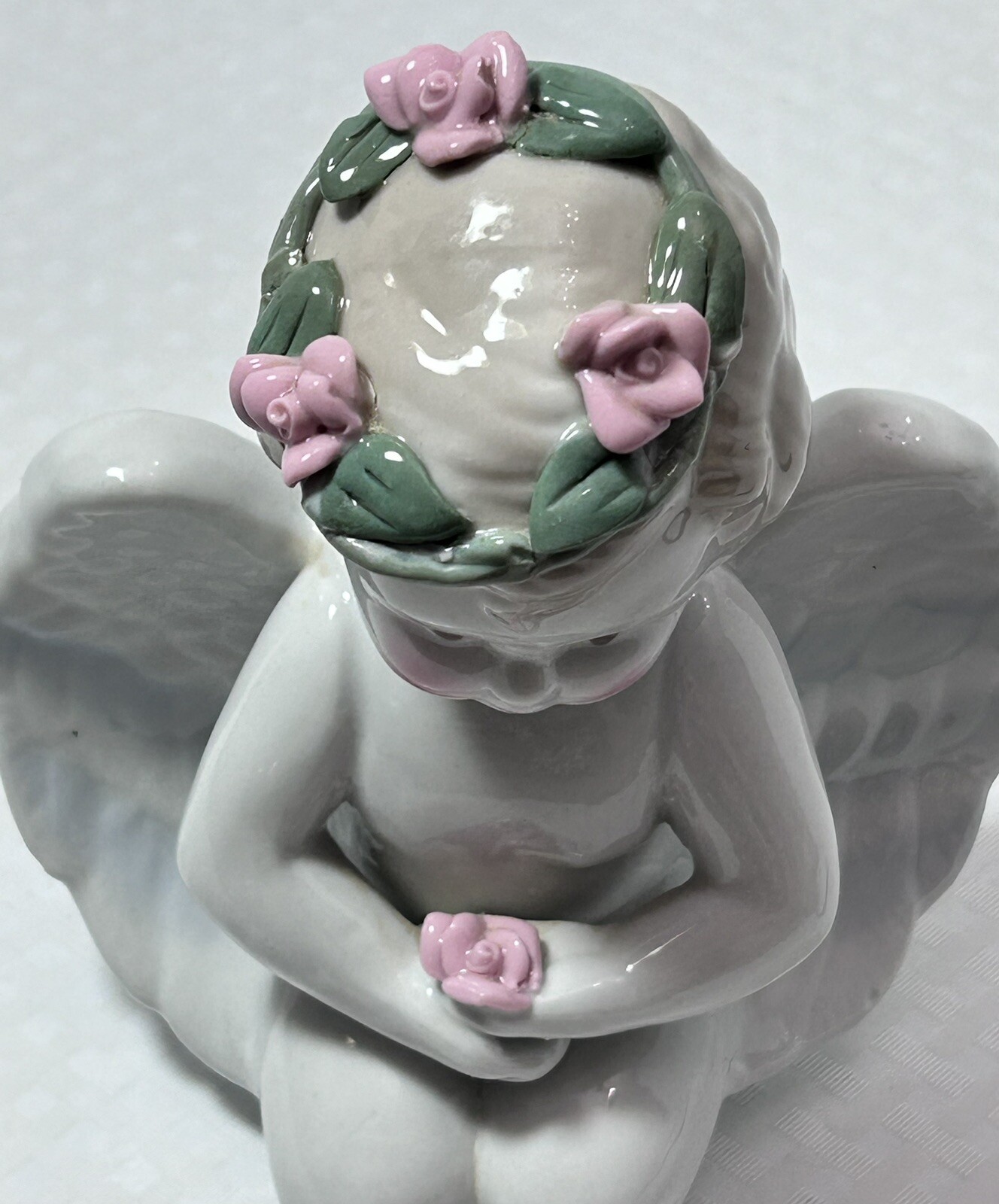 White Ceramic Kneeling Angel Holding Rose Cherub with Rose Wreath Garland 6”