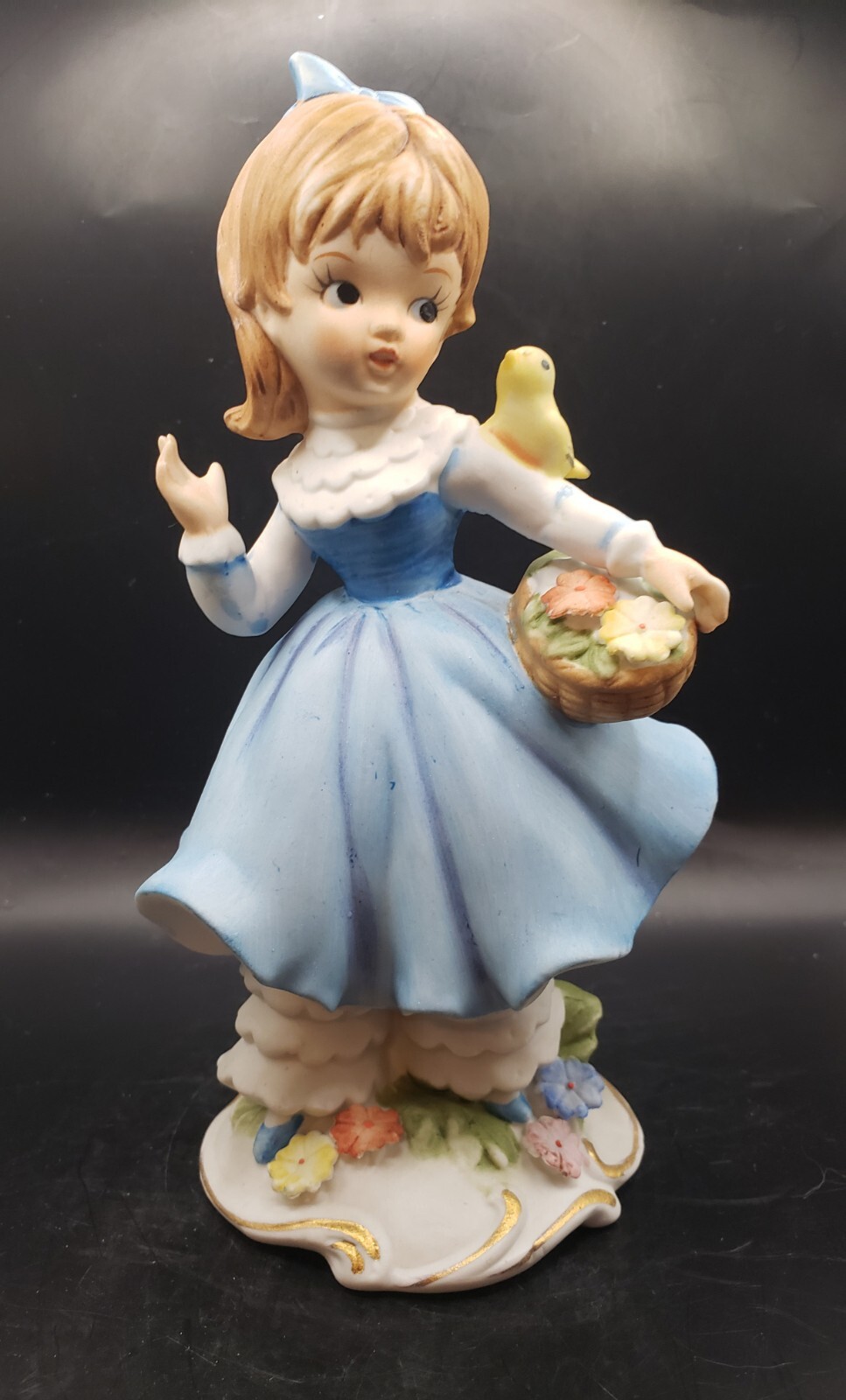 Kitsch ceramic porcelain china girl in blue with a flower basket and yellow Bird