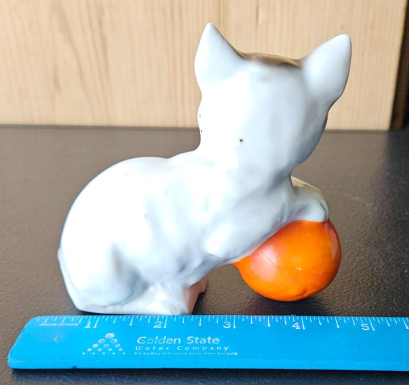 KITTY CAT PLAYING WITH ORANGE BALL. WHITE BLACK CERAMIC FIGURE MADE IN JAPAN.