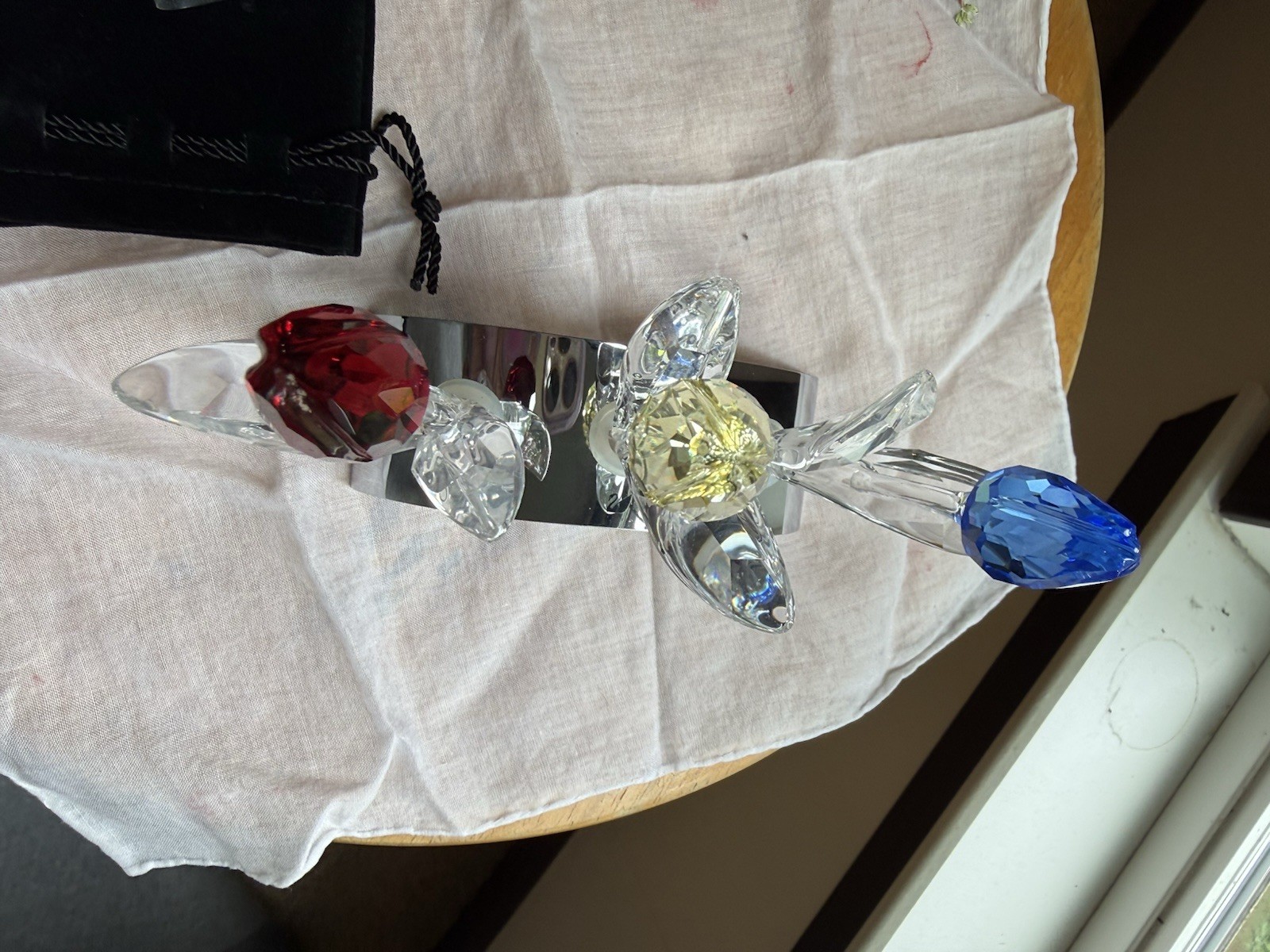 Swarovski Crystal set featuring red, yellow, and blue tulips on mirrored stand