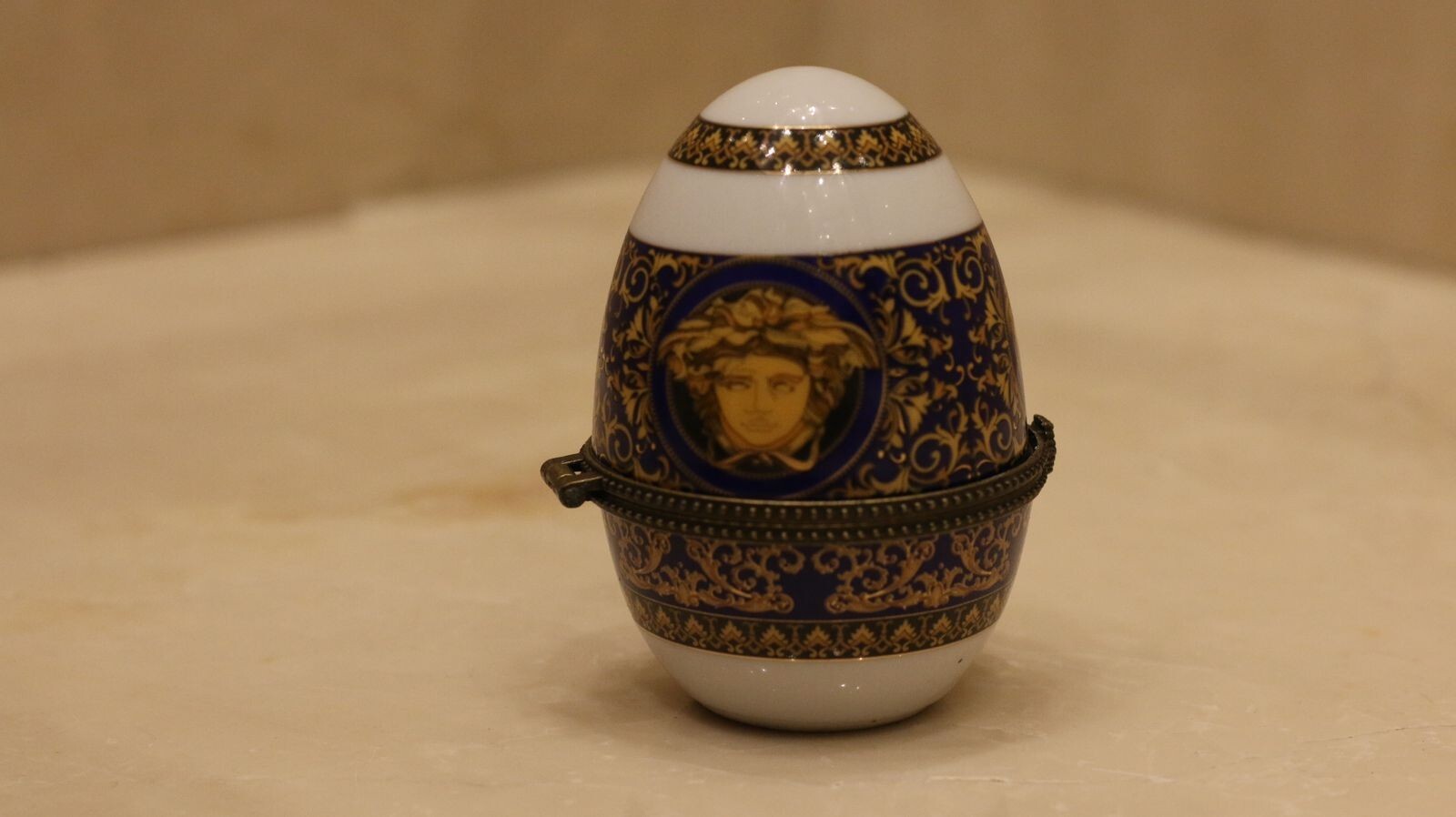 Versace Designs egg in white bohemian porcelain with blue and gold Medusa