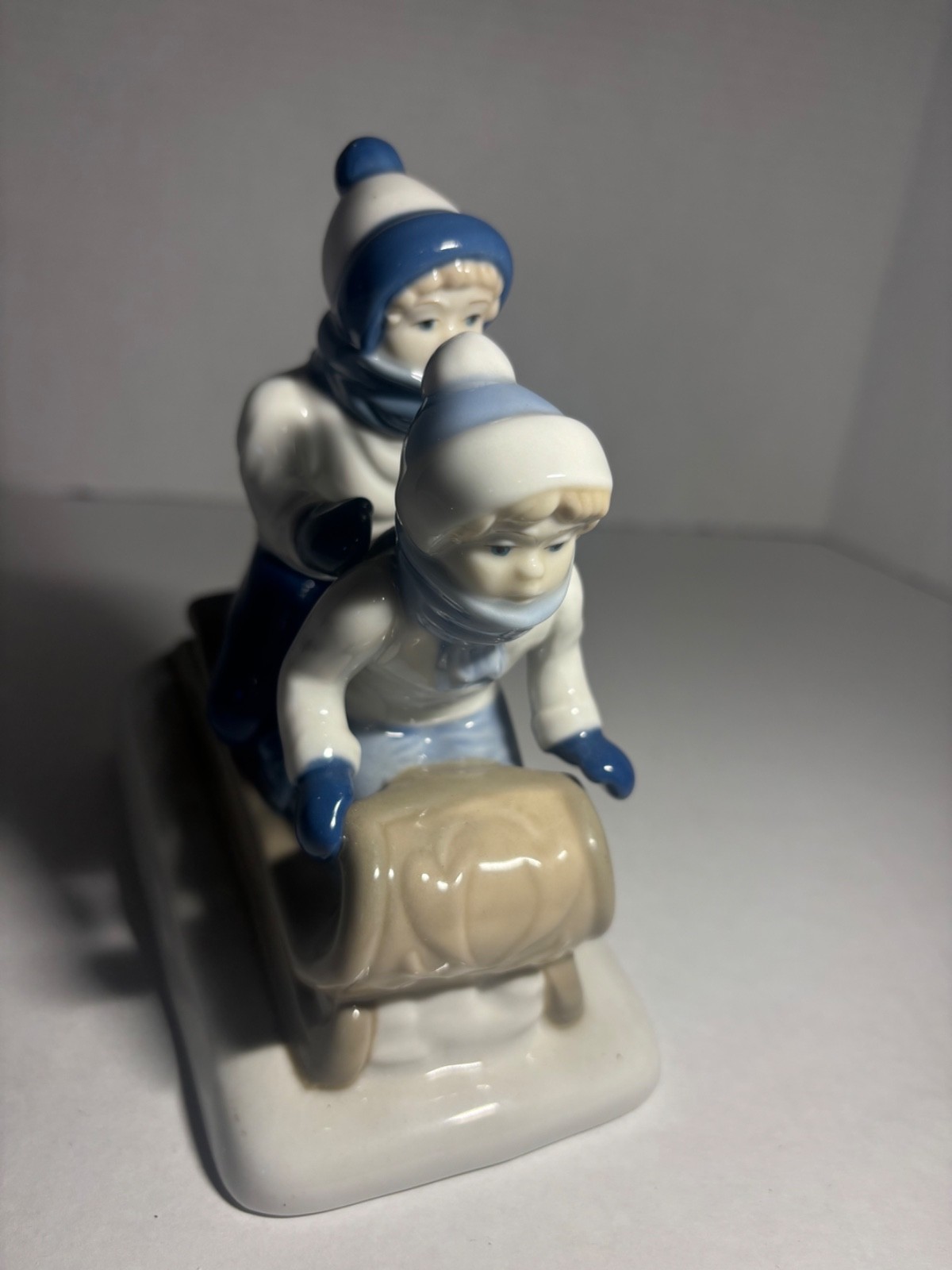 Children Sledding Figurine 6″L glazed ceramic gray & blue winter Christmas