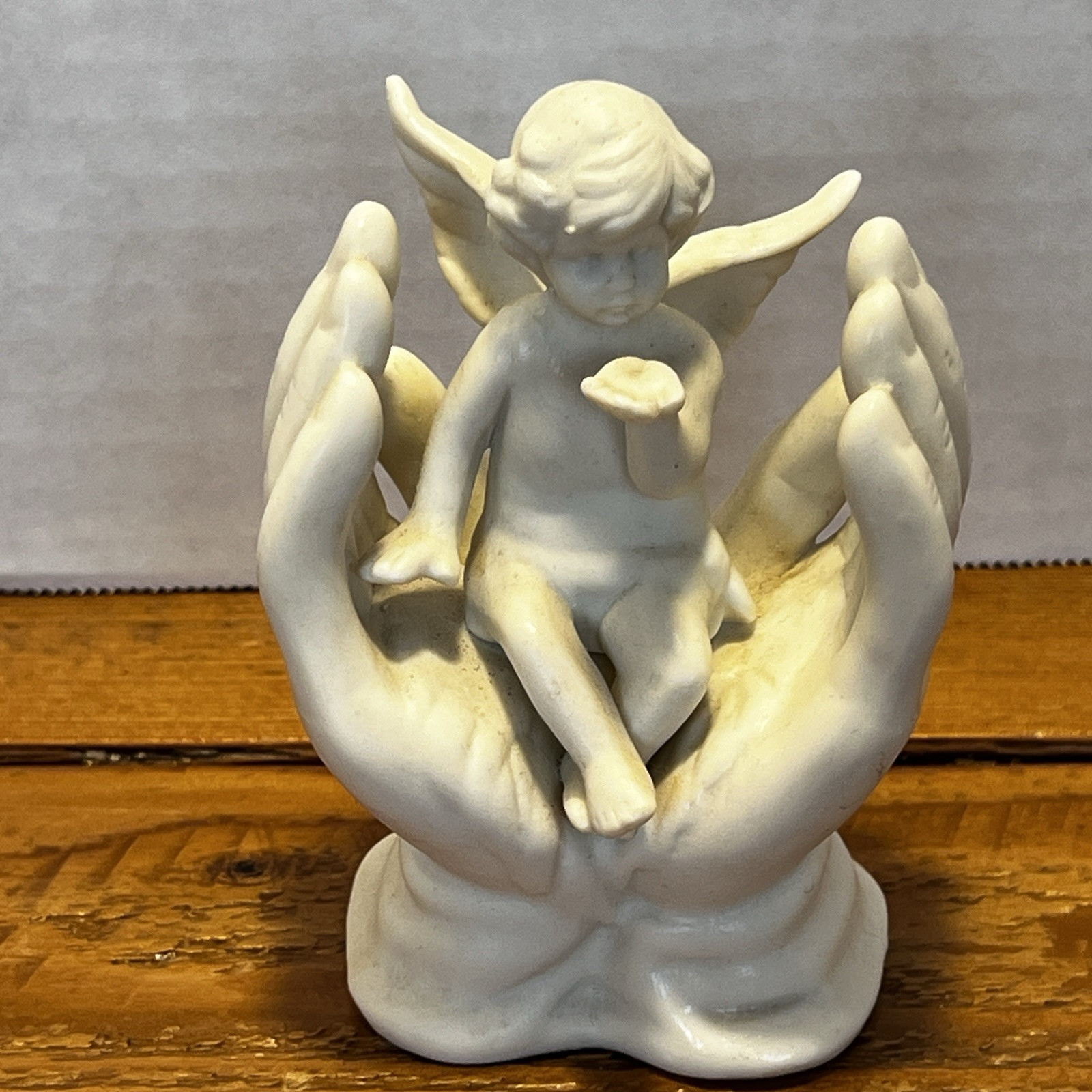 Vintage White Porcelain Figurine~Cherub Angel Sitting in Praying Hands~BEAUTIFUL