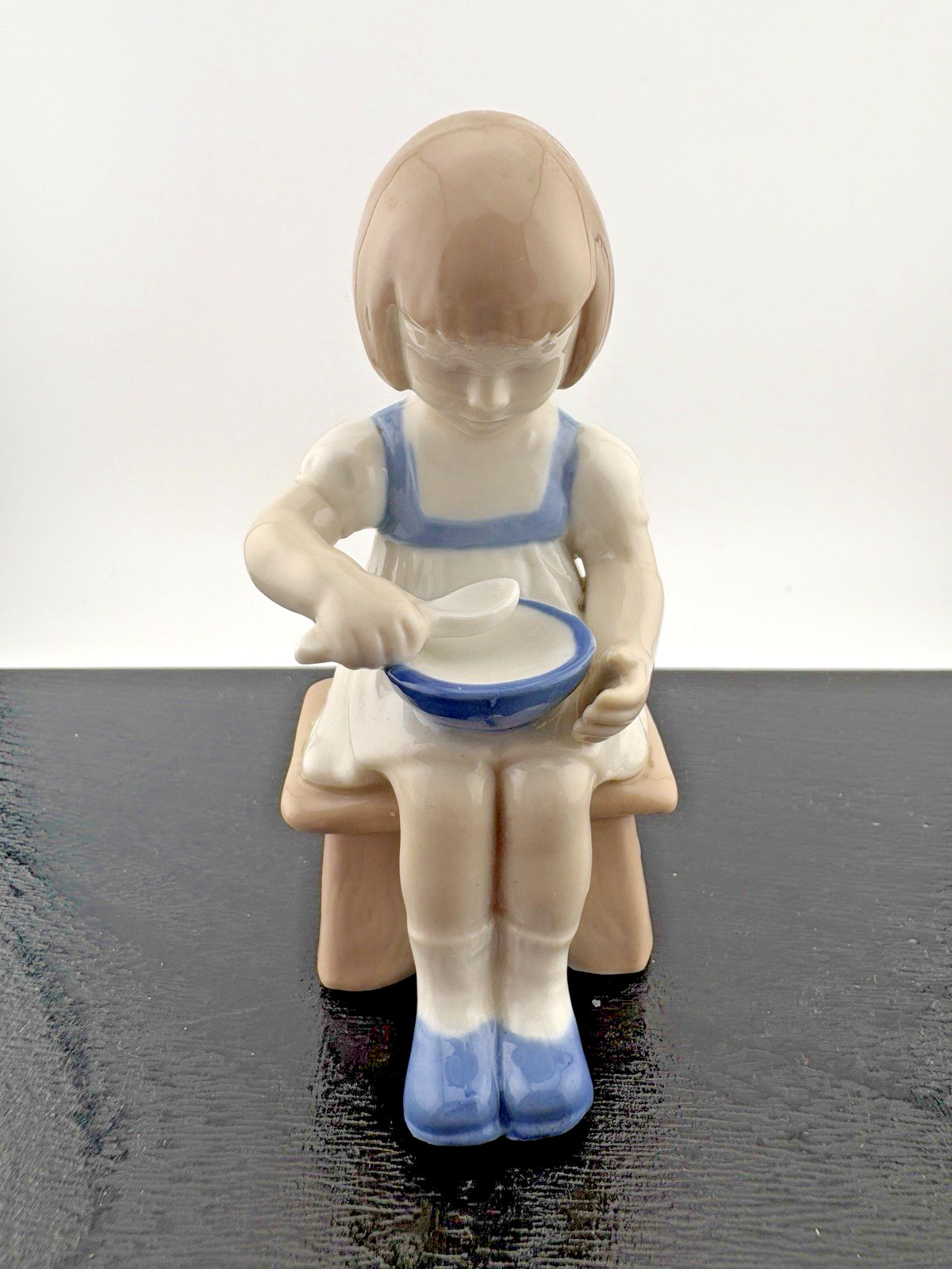 Nao by Lladro Girl eating ceral or soup on a stool figurines design #21778