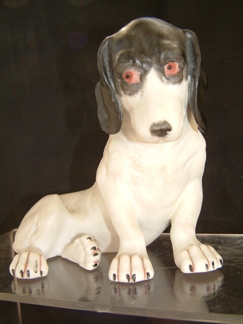 GERMAN GEBRUDER HEUBACH BISQUE FIGURINE OF A BLOODHOUND DOG WITH RED EYES