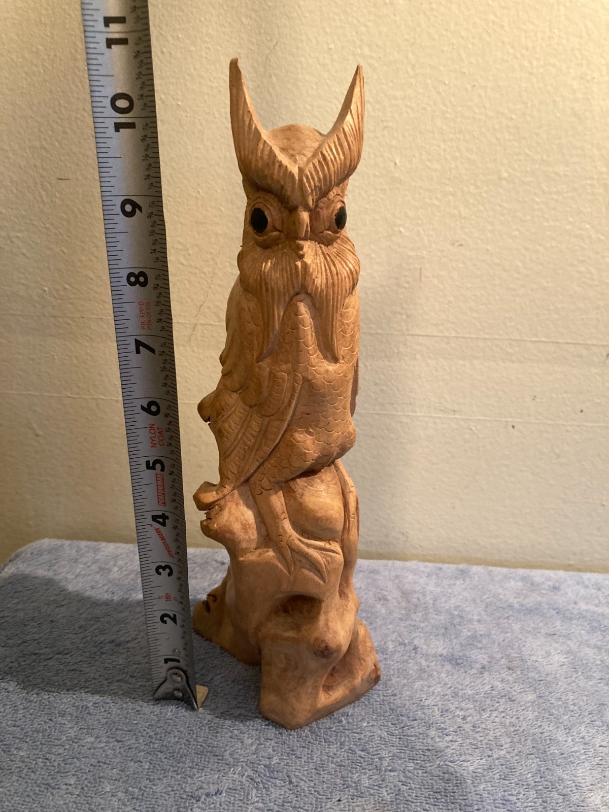 Owl bird statue hand carved from yellow natural wood with natural wood cracks