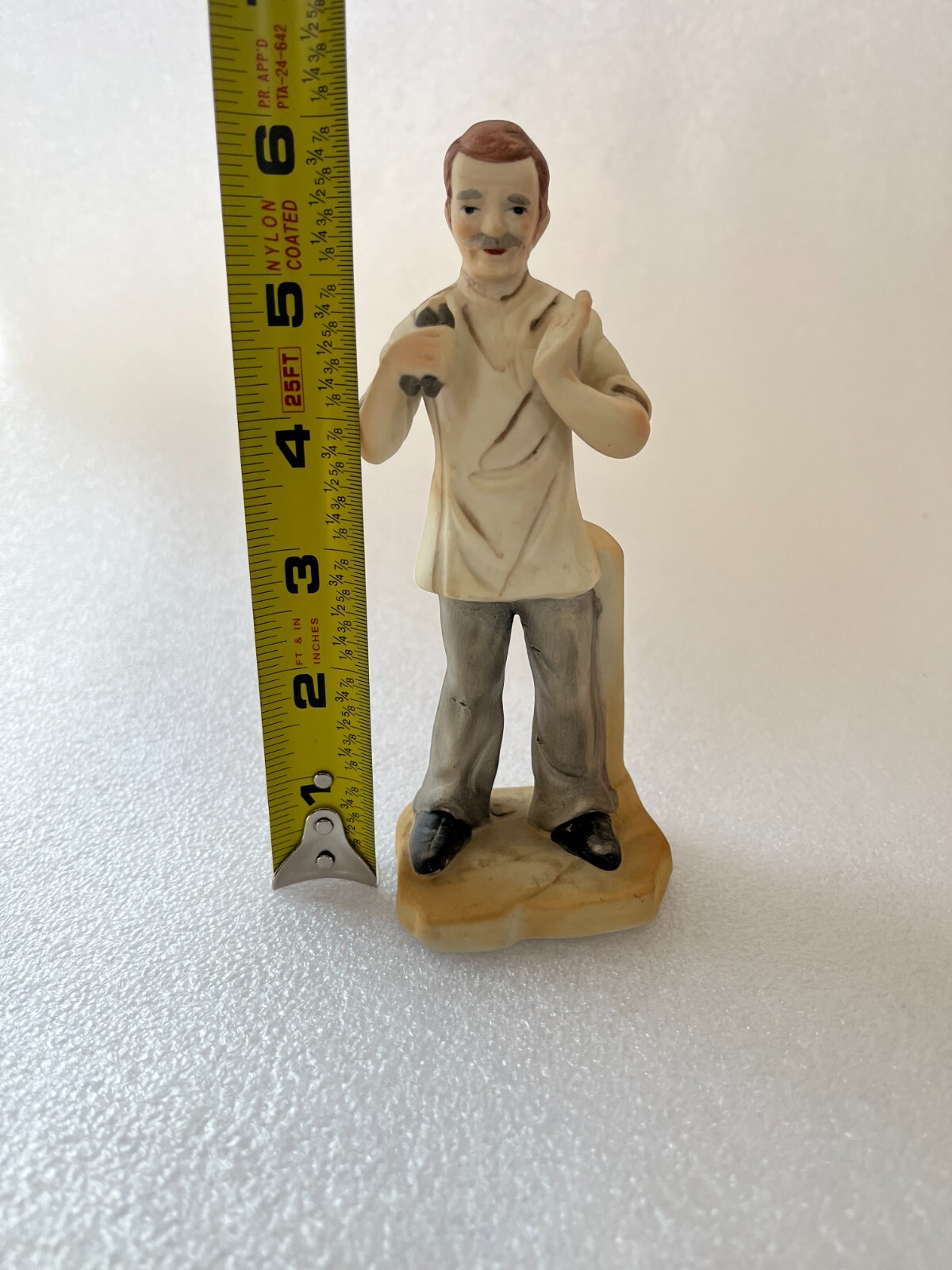 Vintage Porcelain Dentist Figurine Holding extracted tooth