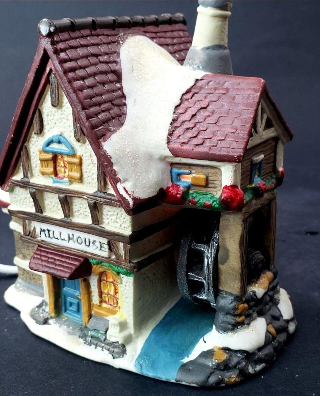 Charming Handcrafted Millhouse Figurine with Snow-Capped Roof and Flowing Water.